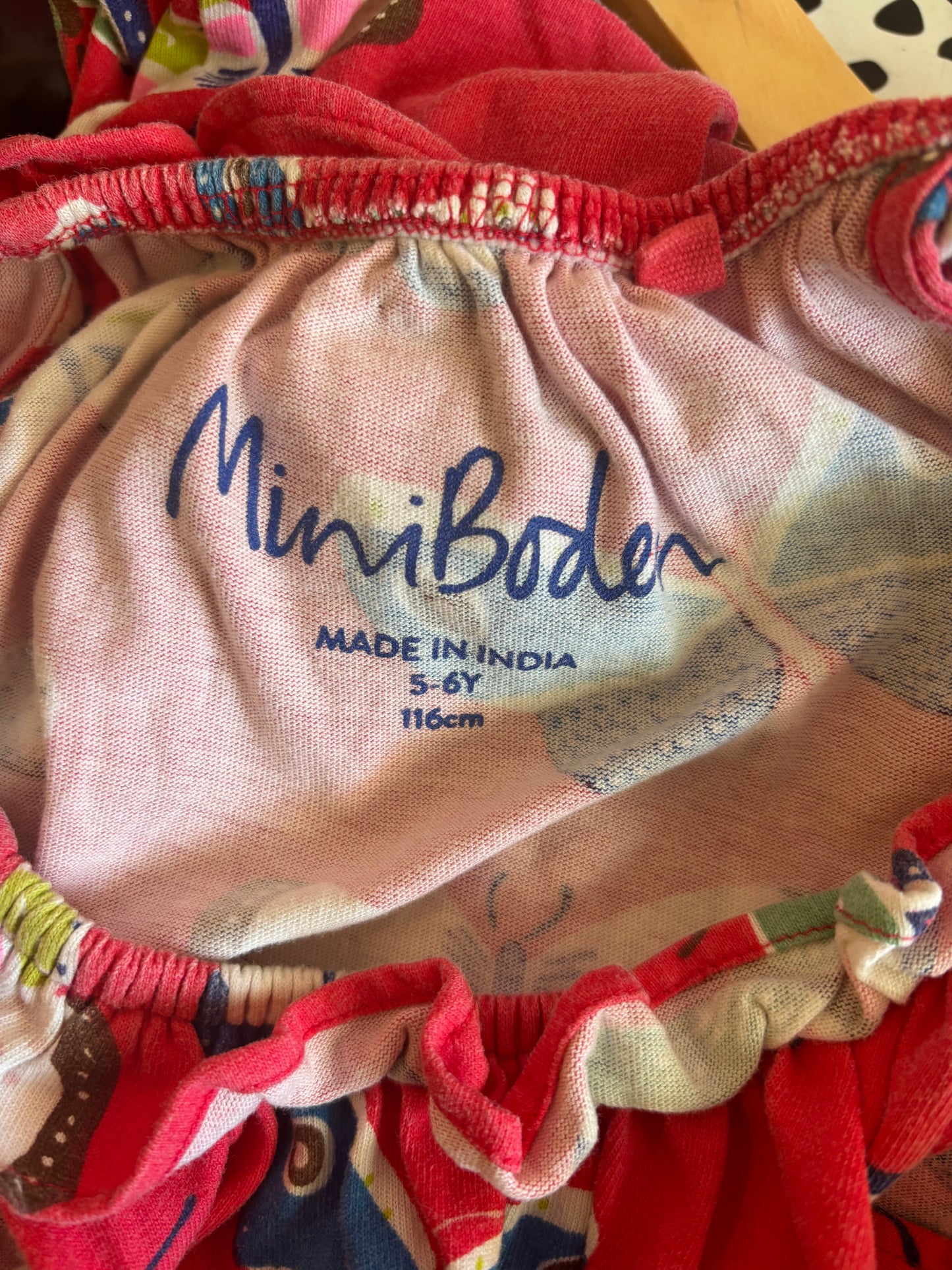 Mini Boden red romper with colorful butterflies. Blue waist tie. Size 5T.