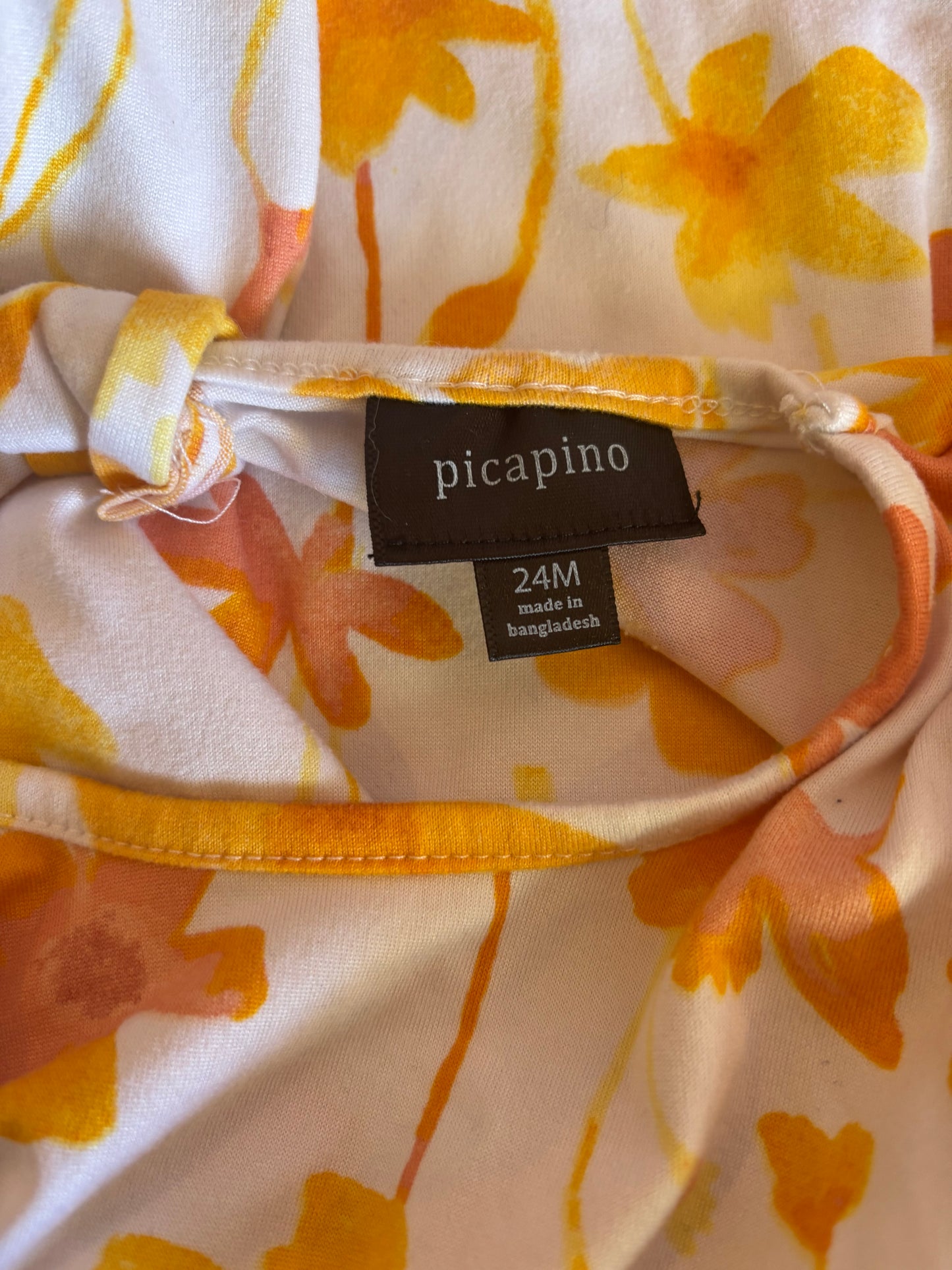 Picapino white dress with yellow & pink flowers. Cap sleeves and small cutout on back. Size 18-24m.