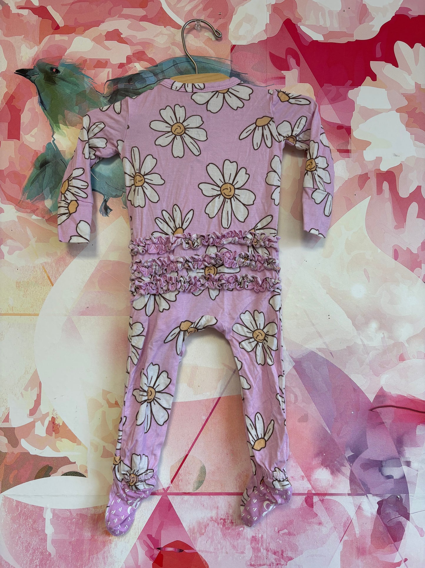 Posh Peanut purple romper with white flowers and ruffle on back. Size 3-6m
