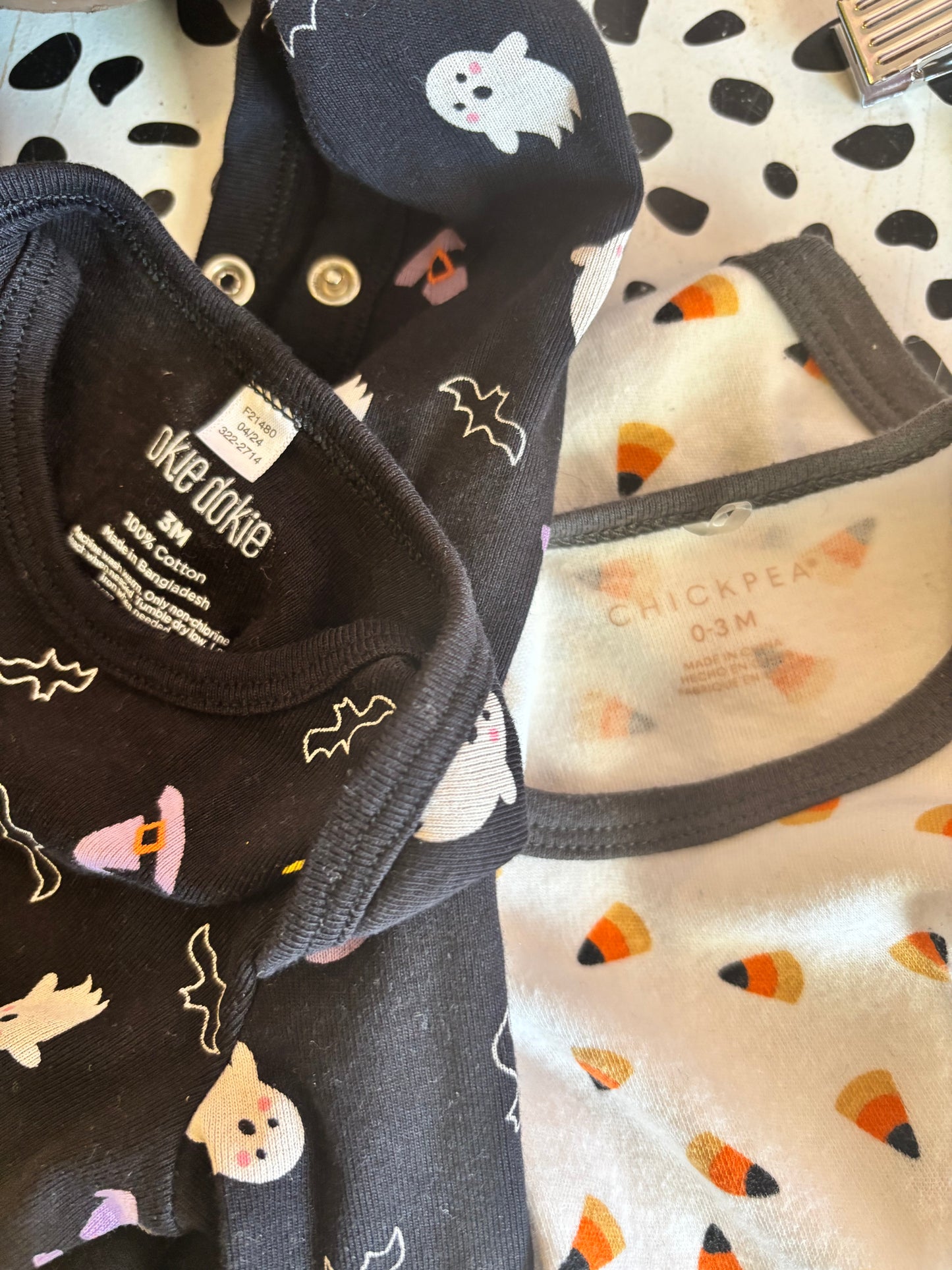 okie dokie black long sleeve footed romper with Halloween ghosts, bats, witch hats, moons. Size 0-3m. Chickpea white long sleeve onesie with orange & black Halloween candy corns. Size 0-3m / NB