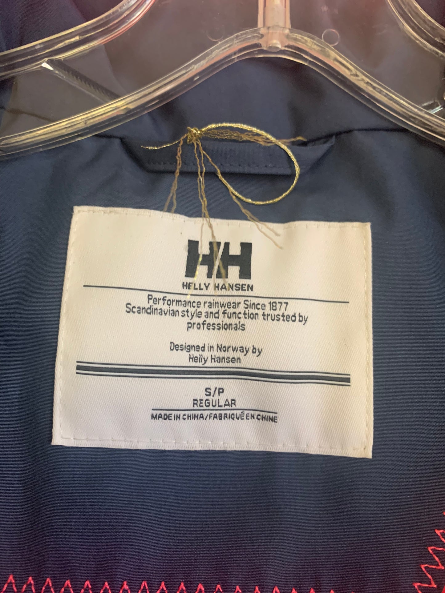 Helly Hansen blue hooded raincoat with bright pink lining. Size Adult S/P.