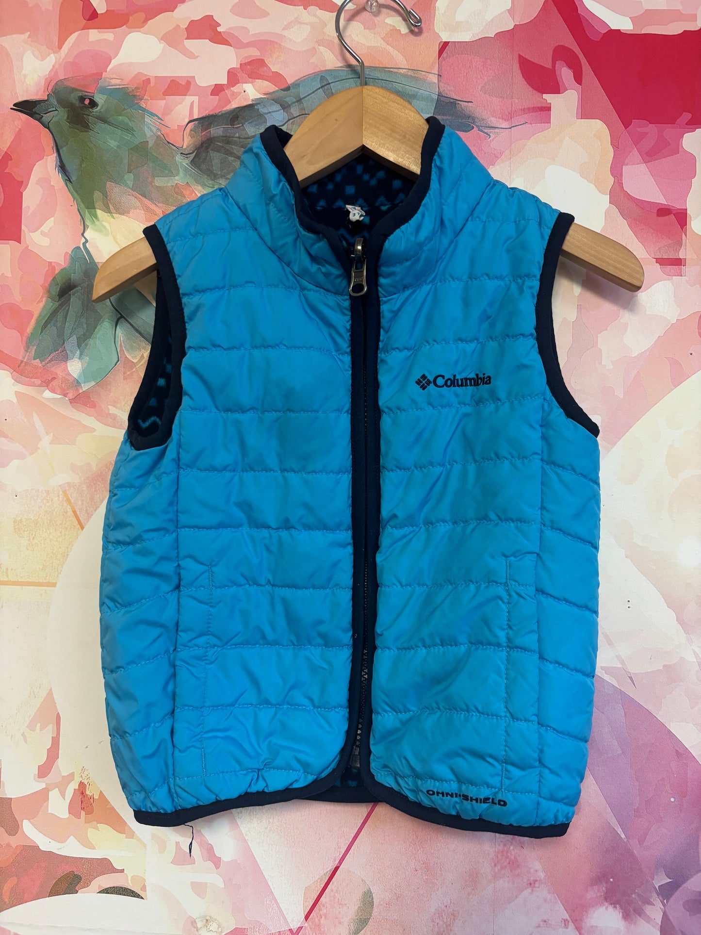Columbia blue puffy vest with reversible fleece side. Size 4T