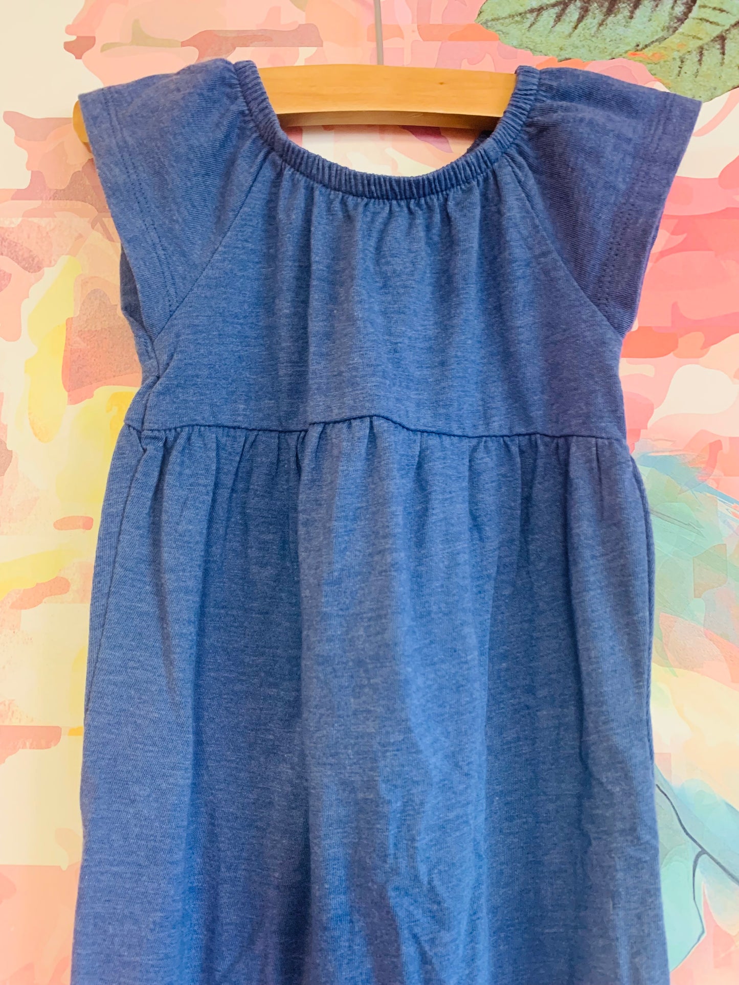 2 Old Navy short sleeve rompers. Solid blue and multi colored flowers. Size 6-12m.