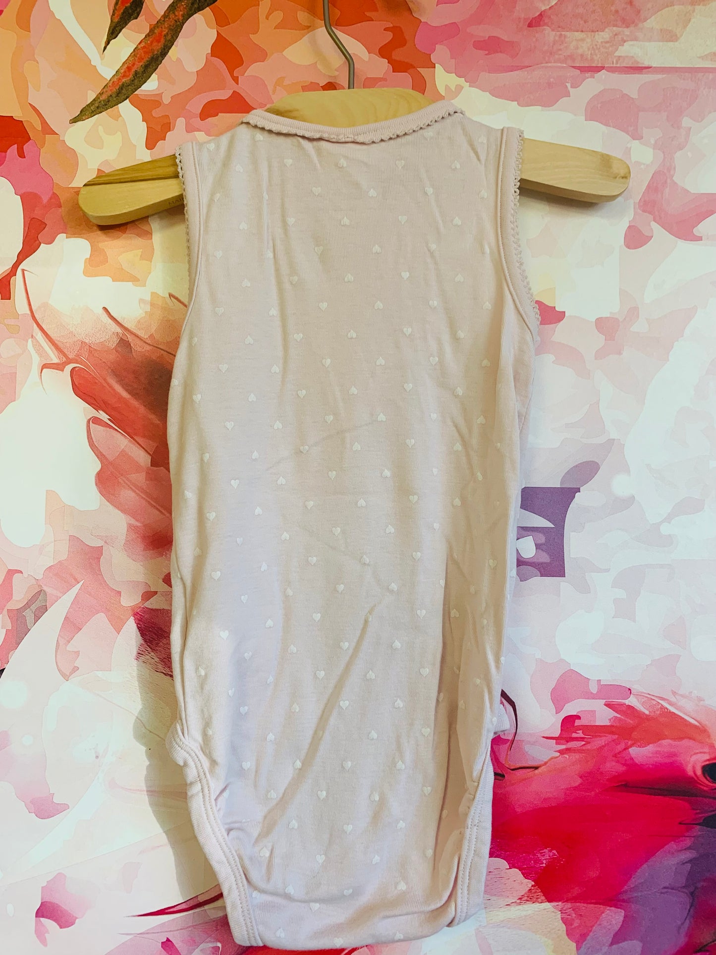 H&M pale pink onesie with tiny white hearts. Size 18-24m