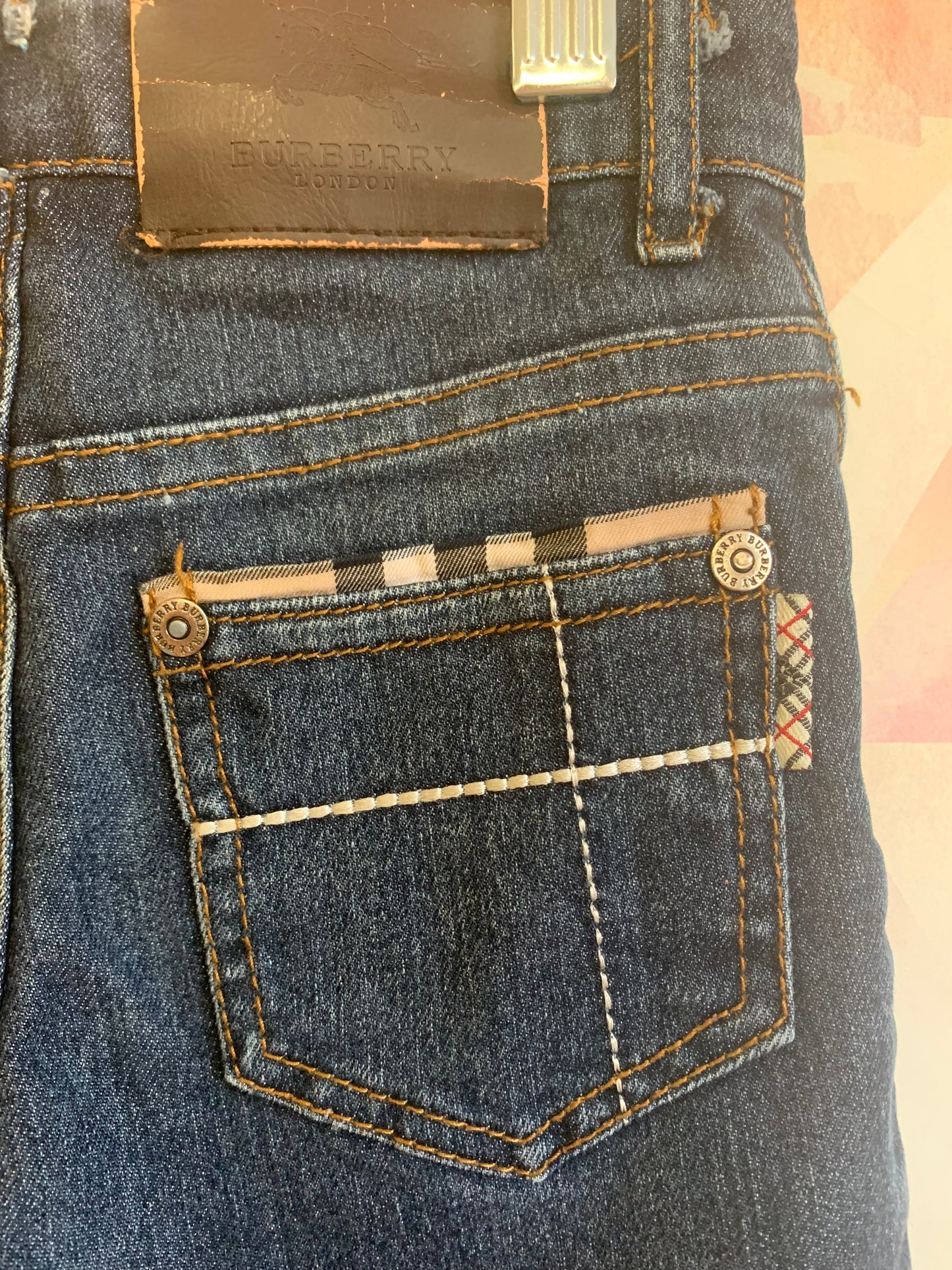 Burberry blue jeans with plaid rolled cuffs and detail on back pockets, inner waistband. Size 3T / 4T