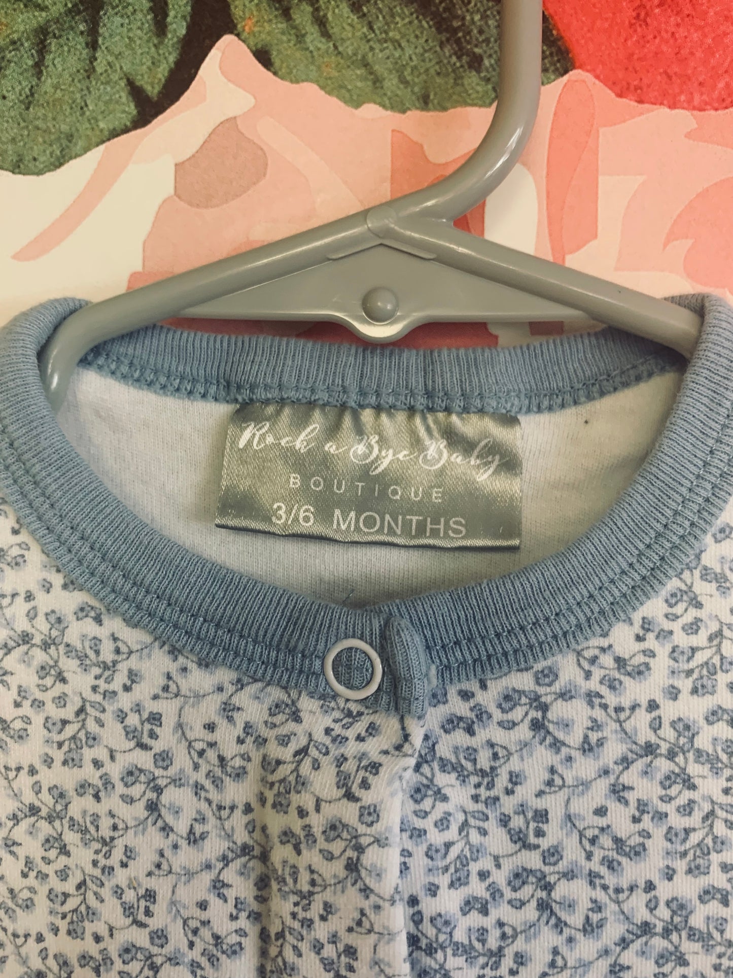 Two long sleeve rompers with snaps. Rock A Bye Baby blue & white flower romper. Size 3-6m. Next Baby white romper. Size 3m