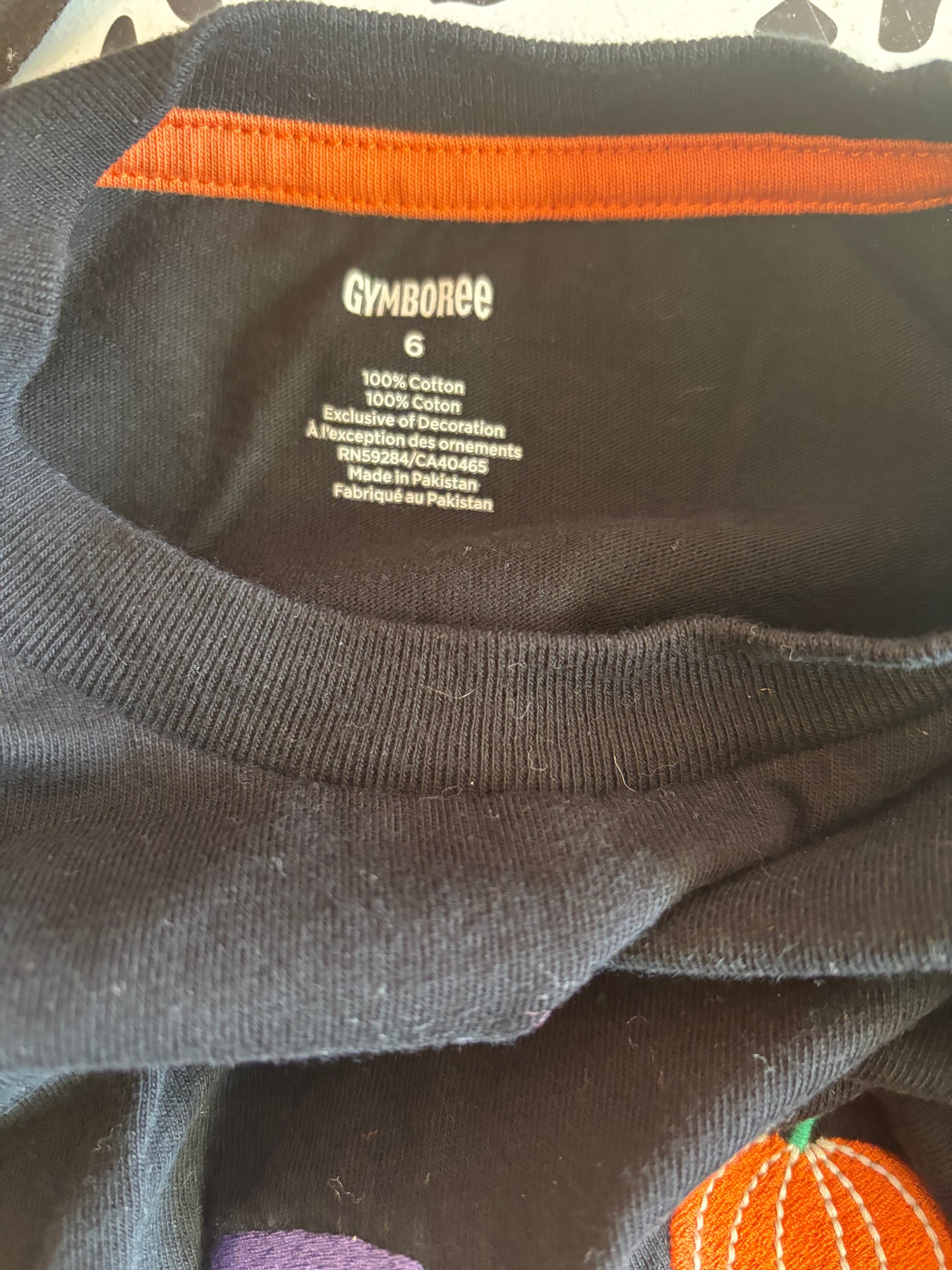 Gymboree black long sleeve shirt with Halloween skeletons on, pumpkins and stripe sleeves. Size 6