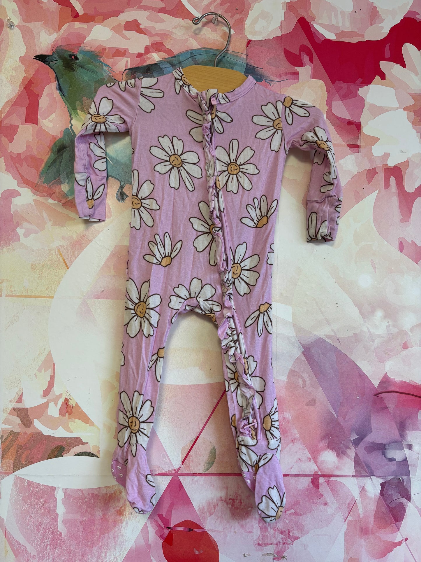 Posh Peanut purple romper with white flowers and ruffle on back. Size 3-6m