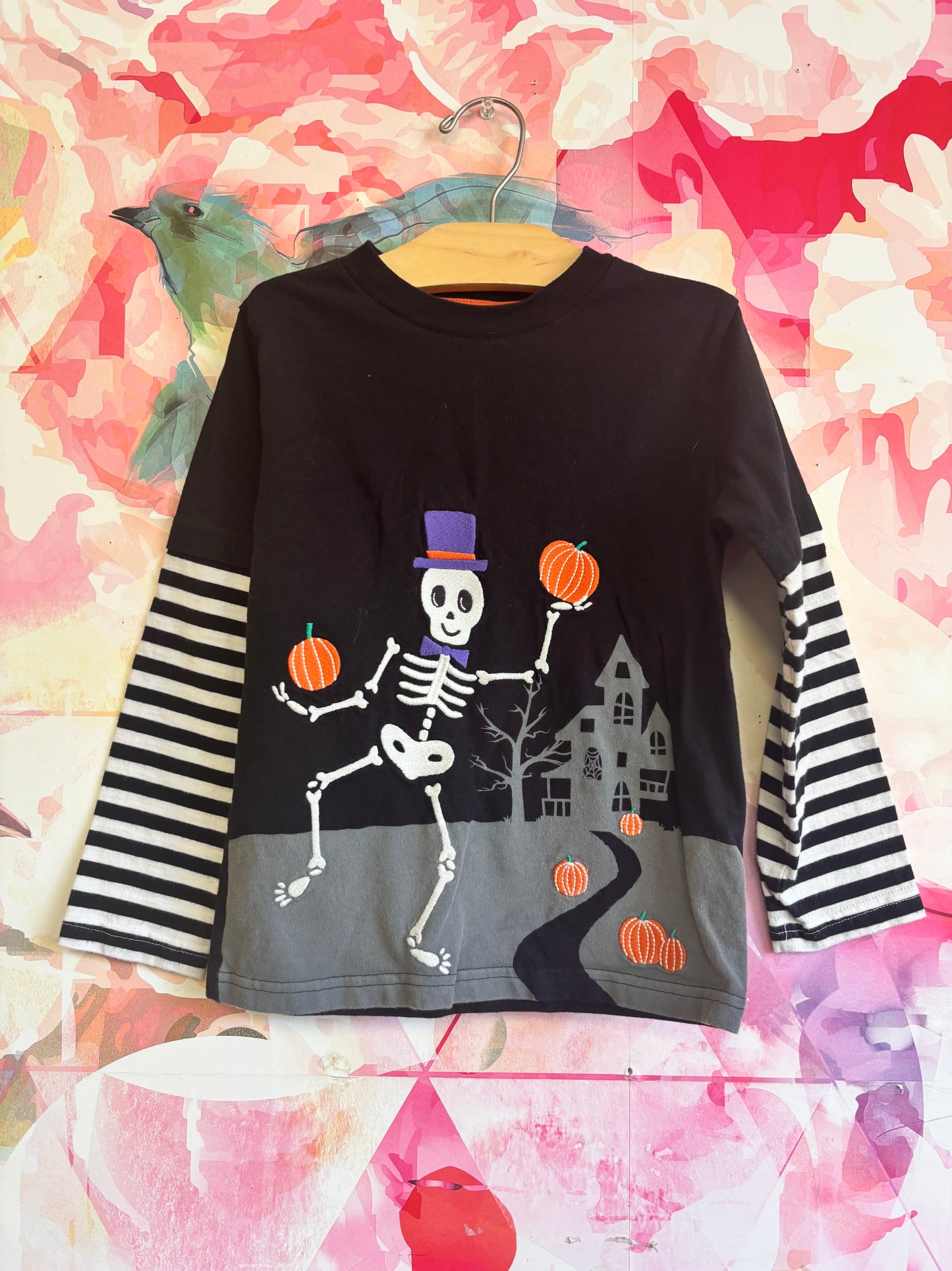 Gymboree black long sleeve shirt with Halloween skeletons on, pumpkins and stripe sleeves. Size 6