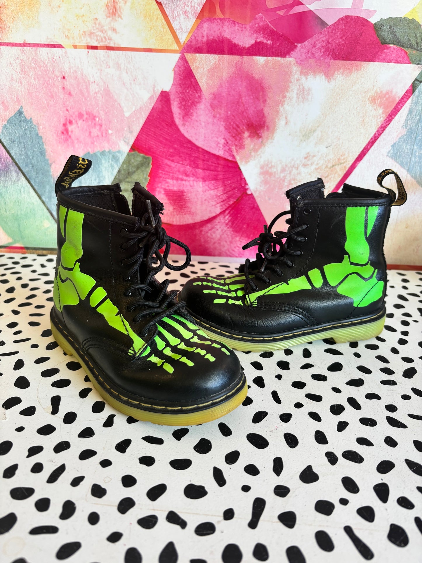 Doc Martens black leather boots with glow in the dark neon green skeleton foot bones. Size 10L.