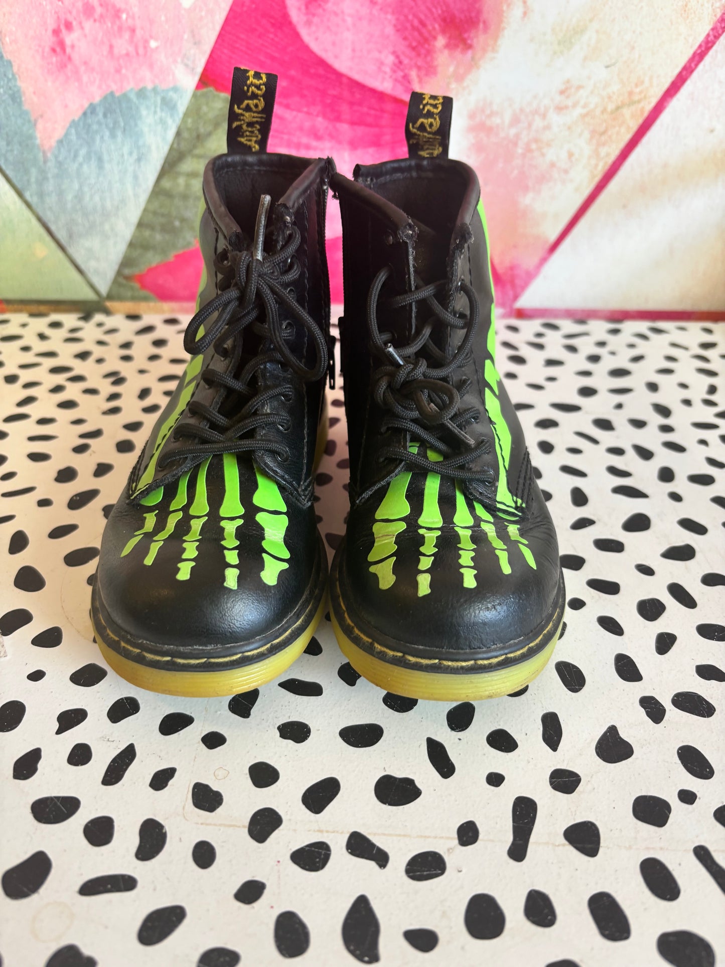 Doc Martens black leather boots with glow in the dark neon green skeleton foot bones. Size 10L.