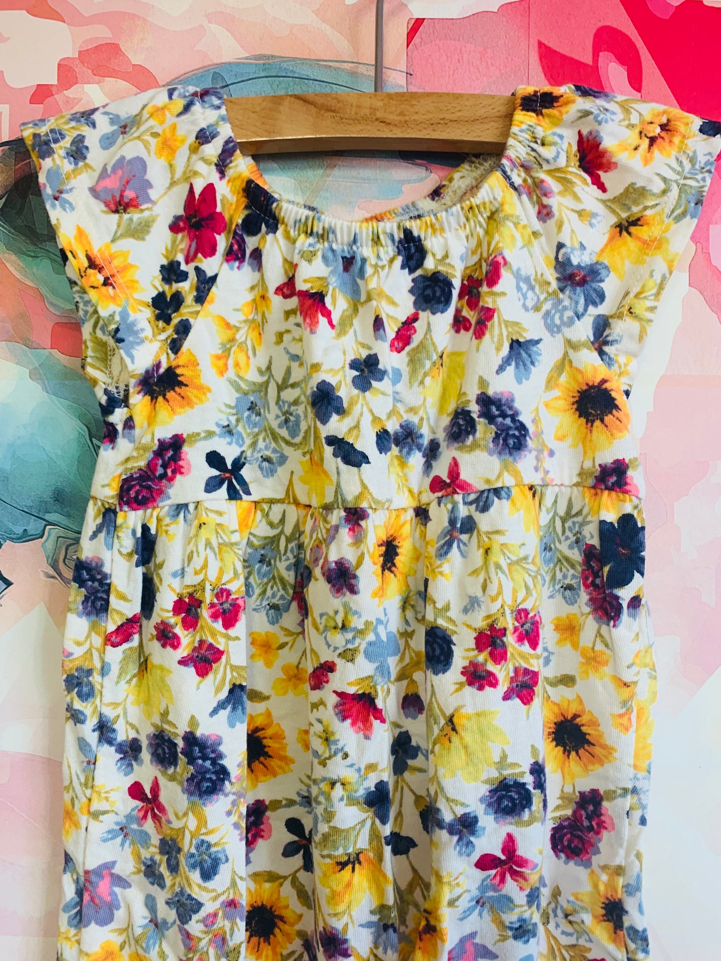 2 Old Navy short sleeve rompers. Solid blue and multi colored flowers. Size 6-12m.