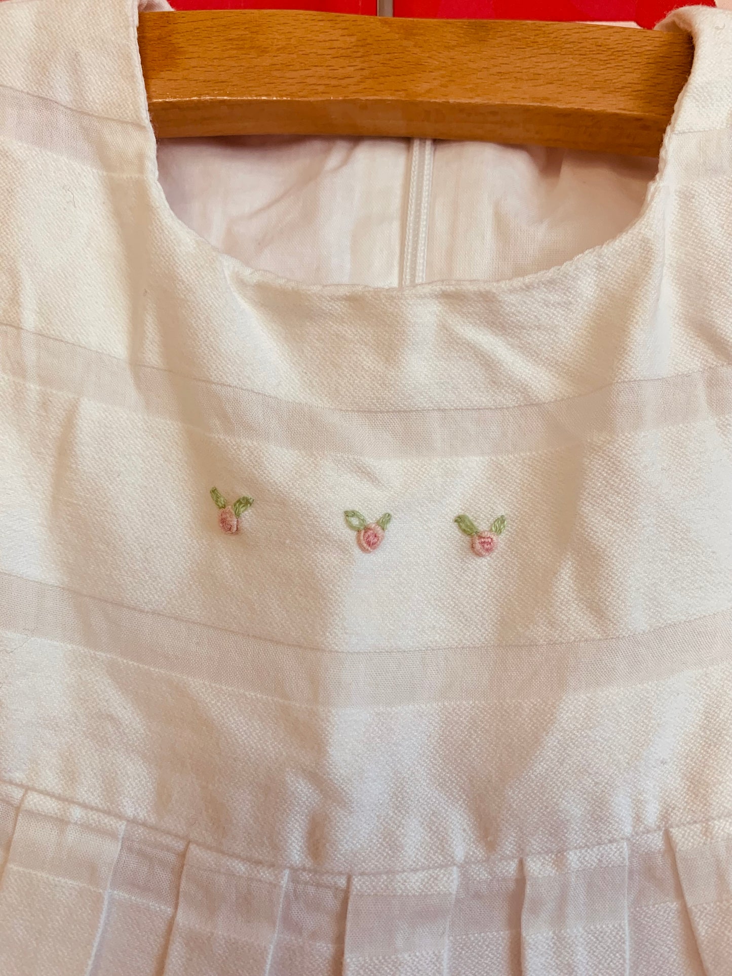 Ciccino white baby dress. Italian brand. 100% cotton. Pleats & tiny pink flowers on neck and front hem. Size 9m.