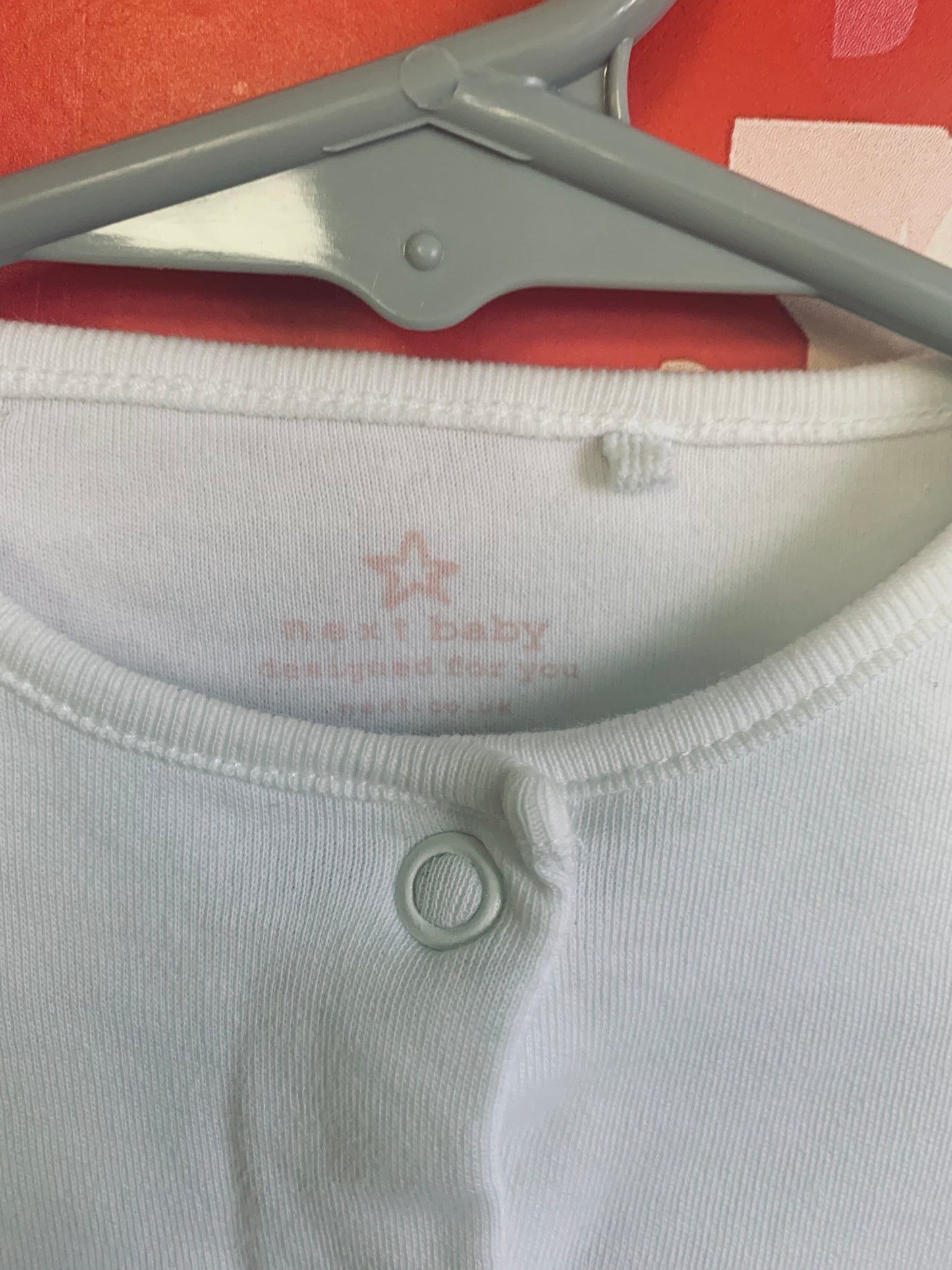 Two long sleeve rompers with snaps. Rock A Bye Baby blue & white flower romper. Size 3-6m. Next Baby white romper. Size 3m