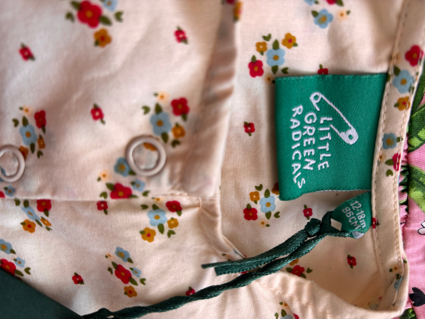 Little Green Radicals cream romper with tiny blue & red & gold flowers. Size 12-18m. NEW WITH TAGS