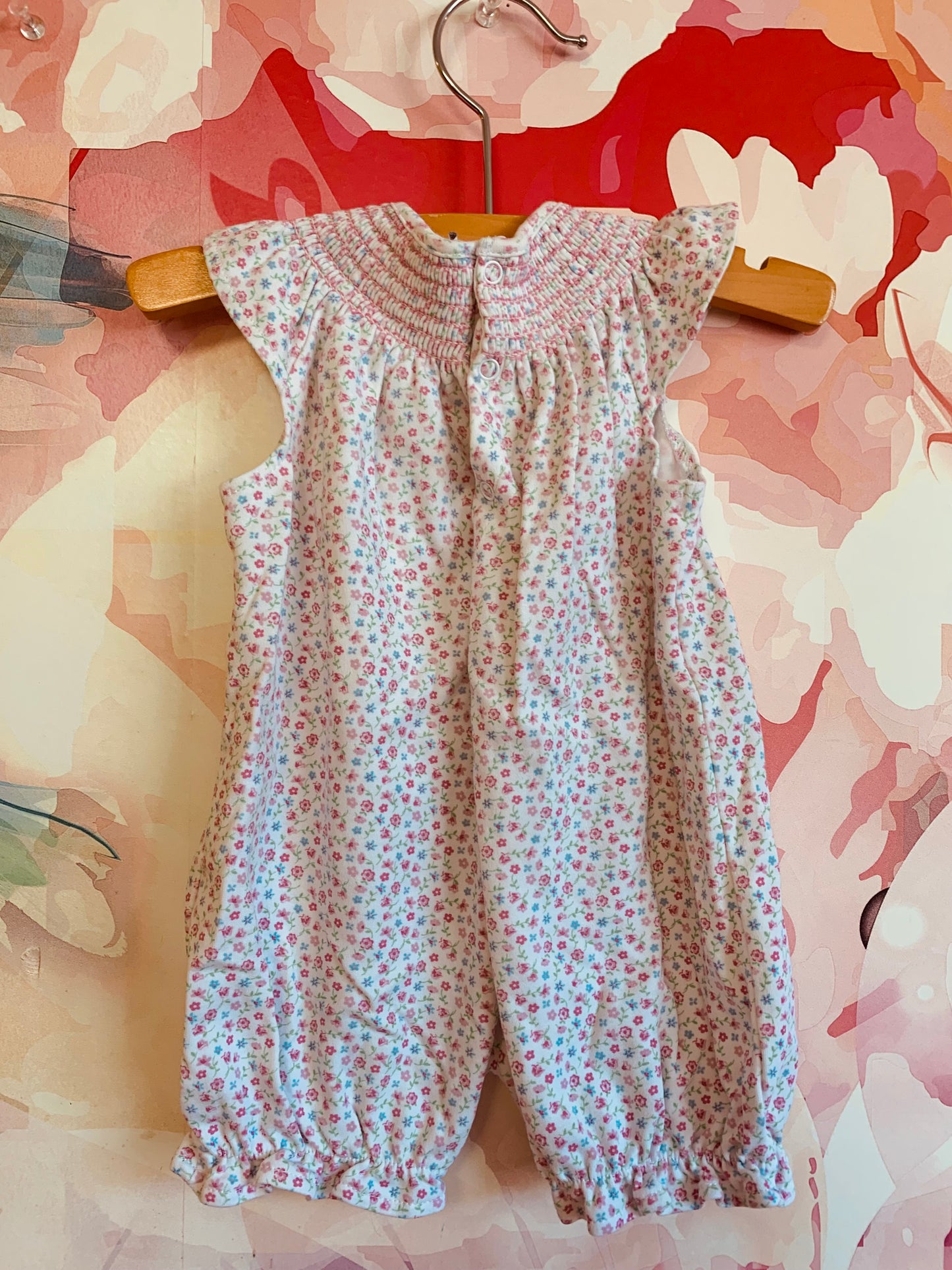 kissy kissy romper pink & blue flowers with smocking on neck. Size 0-3m / NB