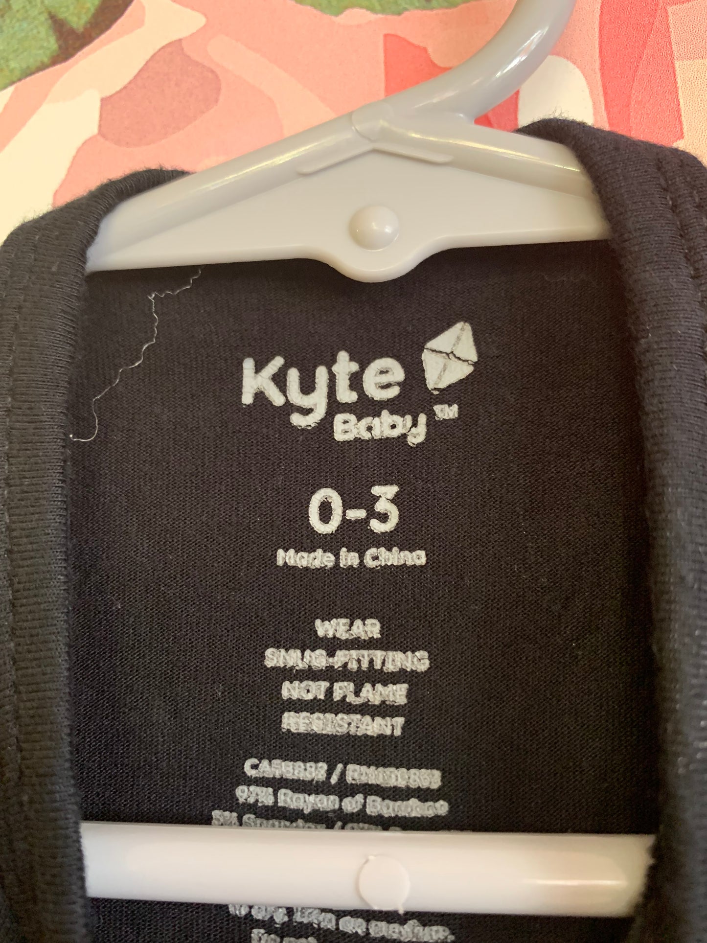 Kyte Black long sleeve romper with white constellations. Primary Red long sleeve romper. Size 0-3m / NB