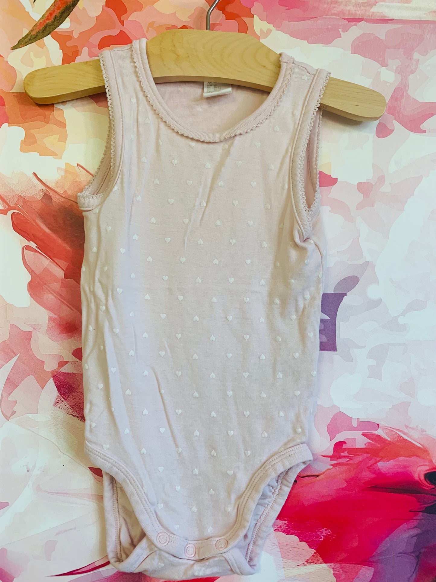 H&M pale pink onesie with tiny white hearts. Size 18-24m