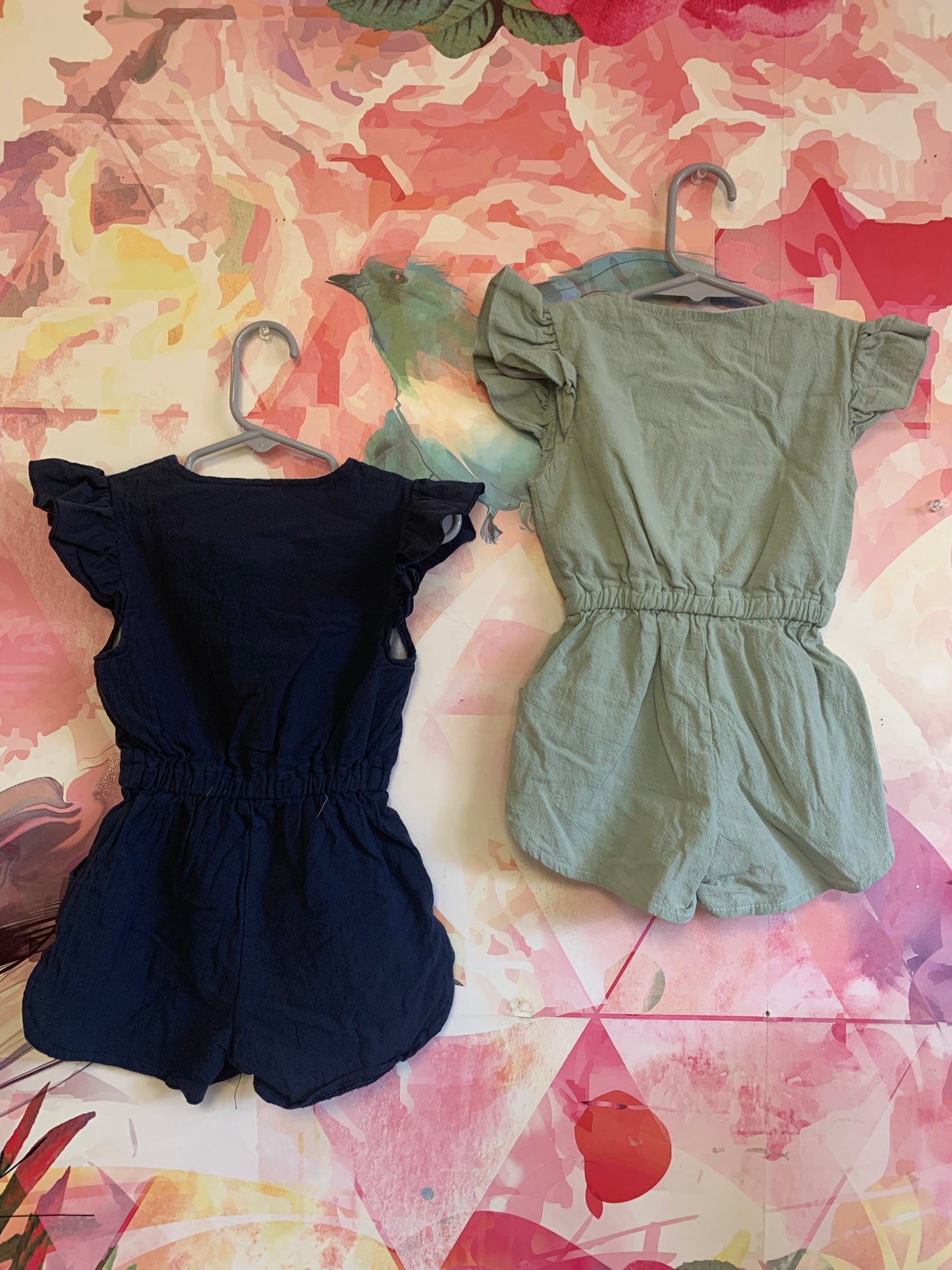 Blue and Green short sleeve rompers with buttons down front & front pockets. Size 4T.