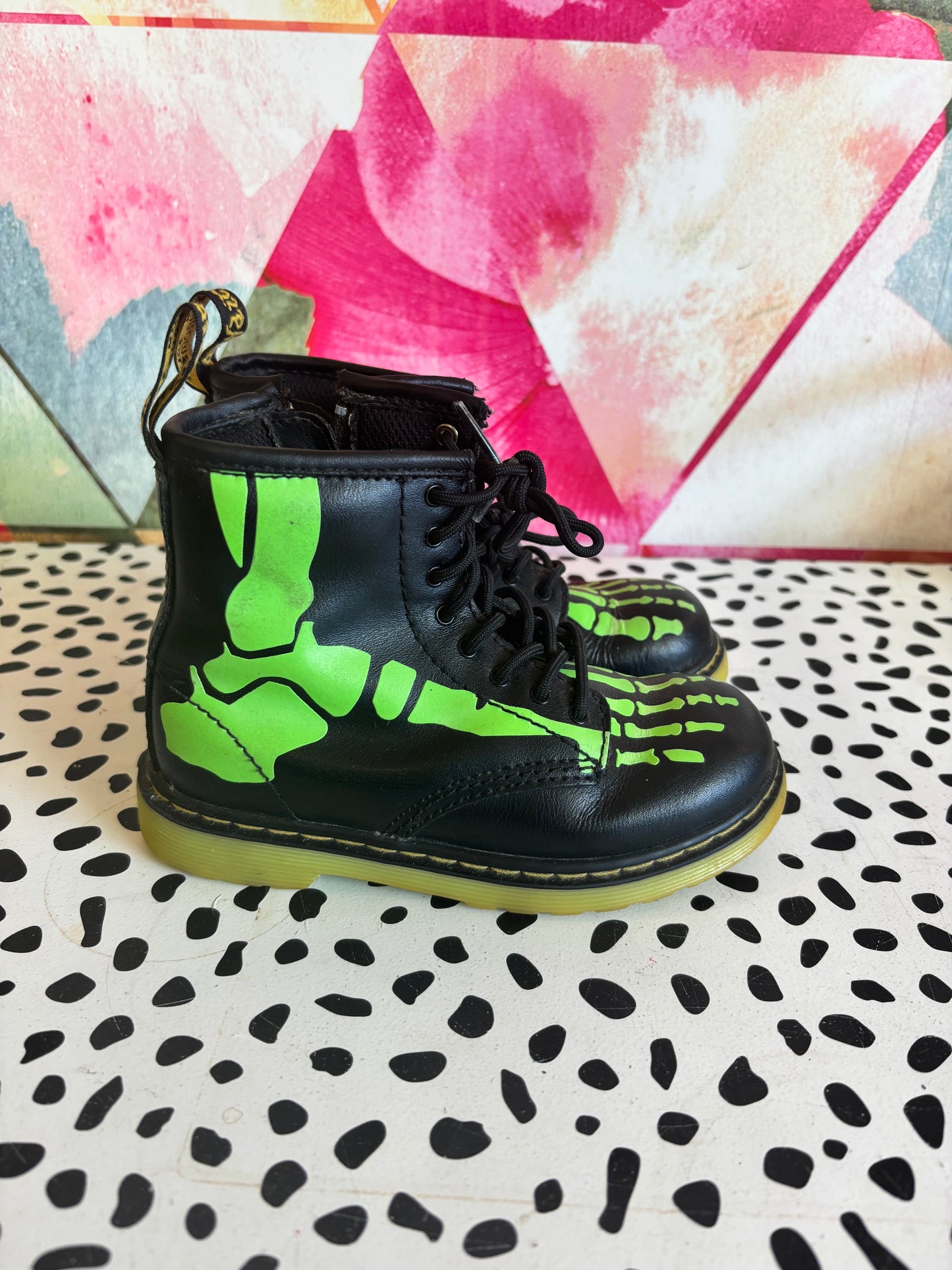 Doc Martens black leather boots with glow in the dark neon green skeleton foot bones. Size 10L.