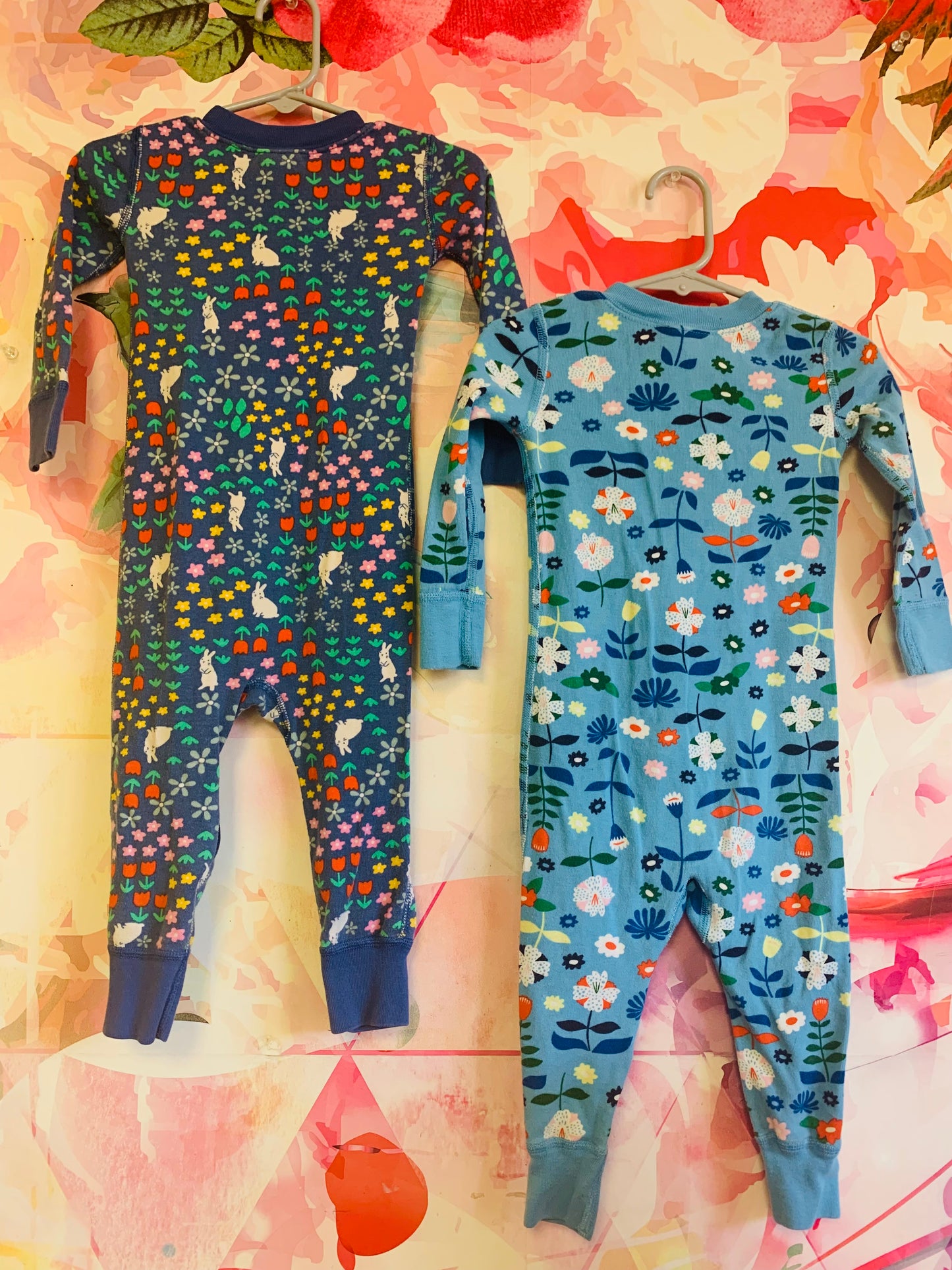 Hanna Andersson zipped up rompers. Navy blue with bunnies and flowers. Light blue with colorful flowers. Size 18-24m