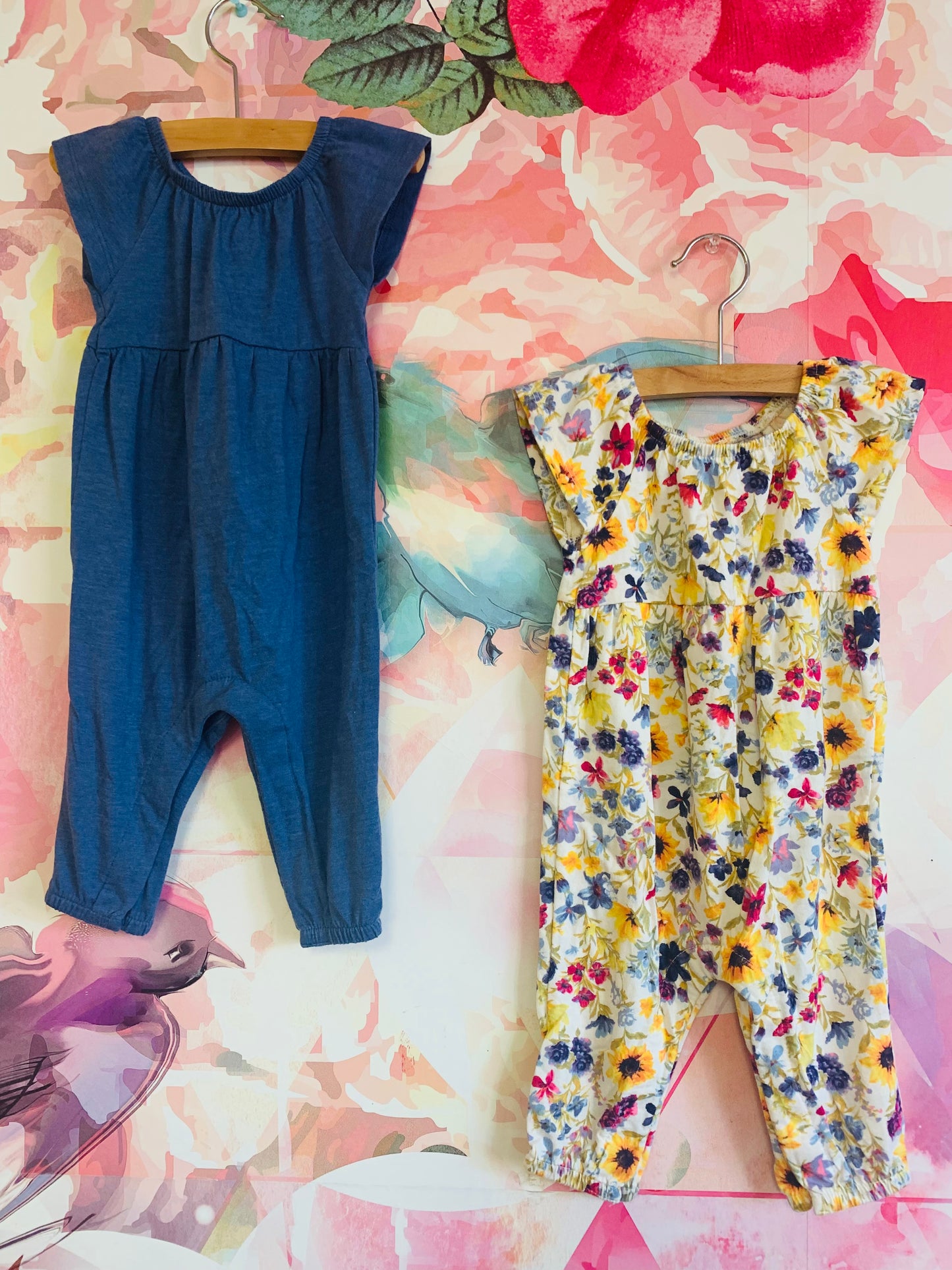 2 Old Navy short sleeve rompers. Solid blue and multi colored flowers. Size 6-12m.