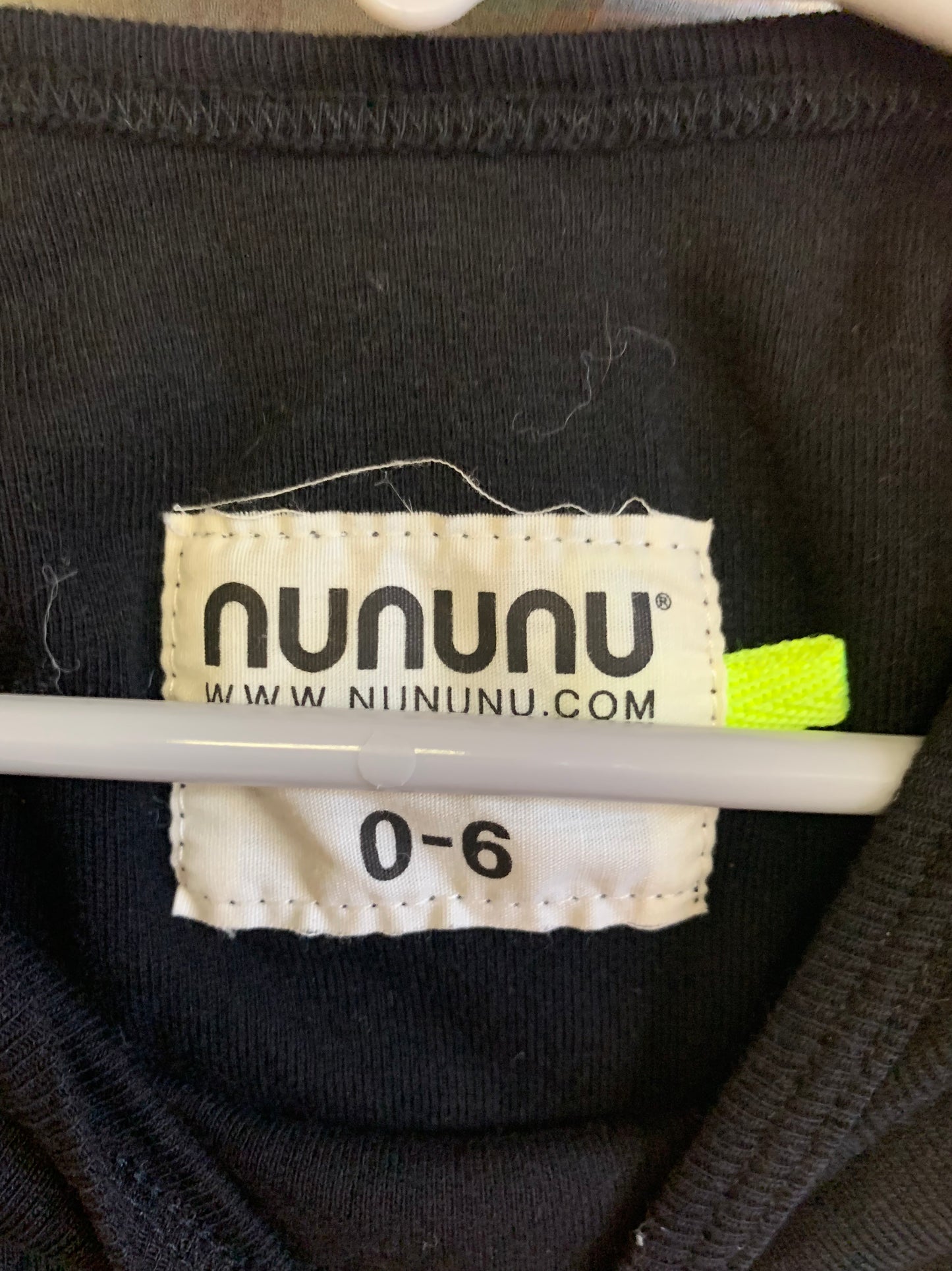 nununu black long sleeve romper with silver skirt and grey stars. Size 0-6m