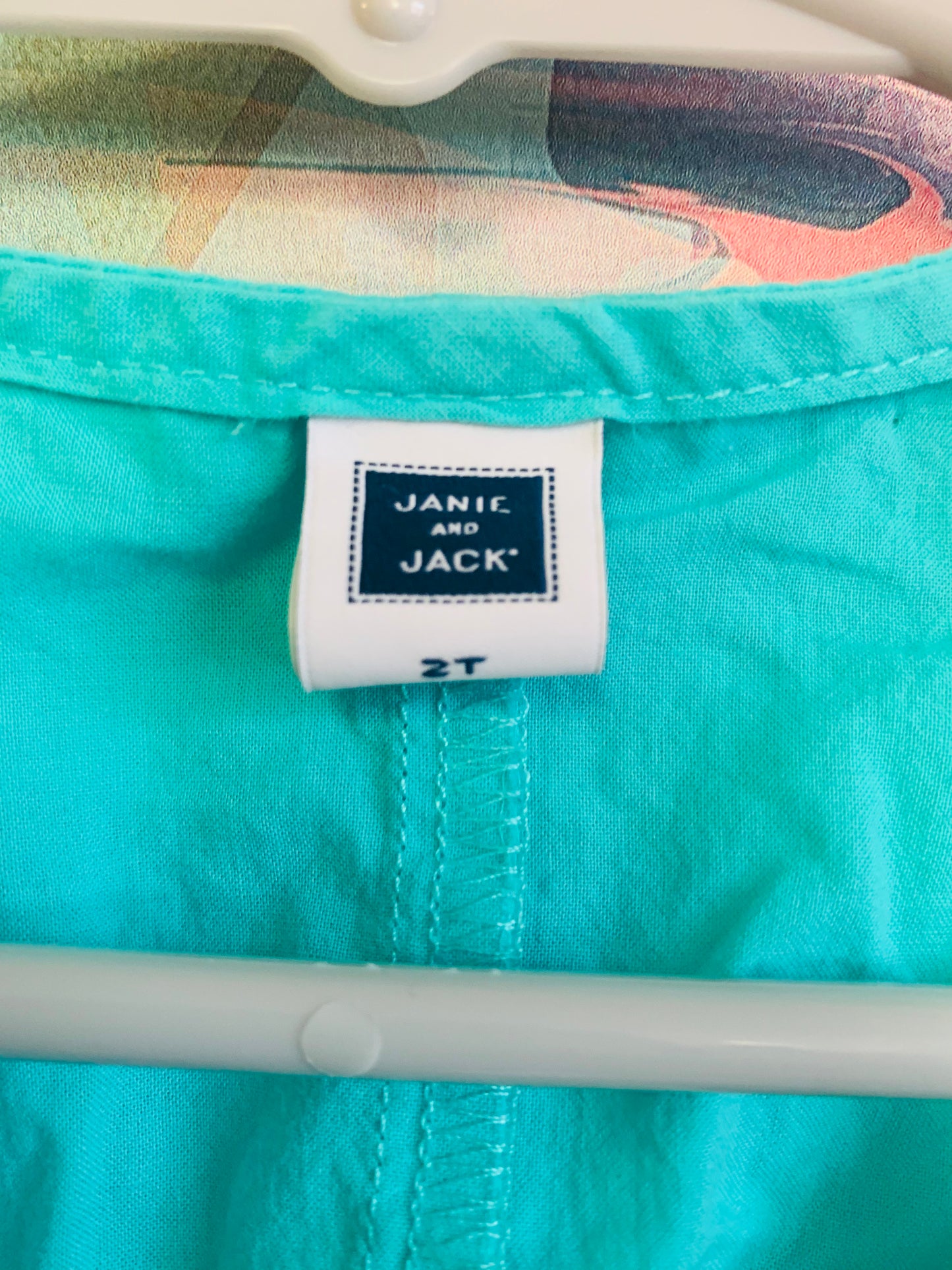 Janie & Jack green shirt sleeve top and Oshkosh pink, blue, white pattern skort. Size 2T.