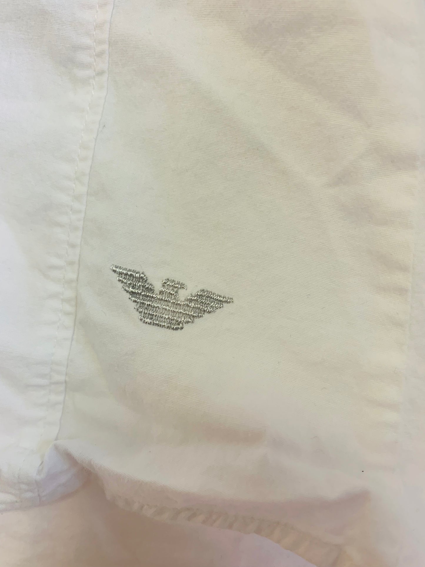 Armani Junior white button down cotton collared blouse with ruffle along clear buttons. Extra button attached - see pics. Size 8.