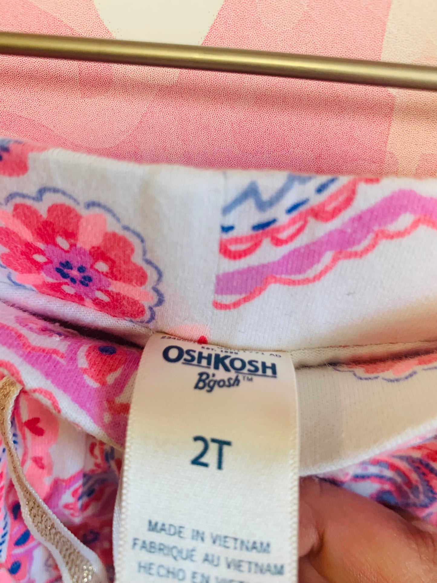 Janie & Jack green shirt sleeve top and Oshkosh pink, blue, white pattern skort. Size 2T.