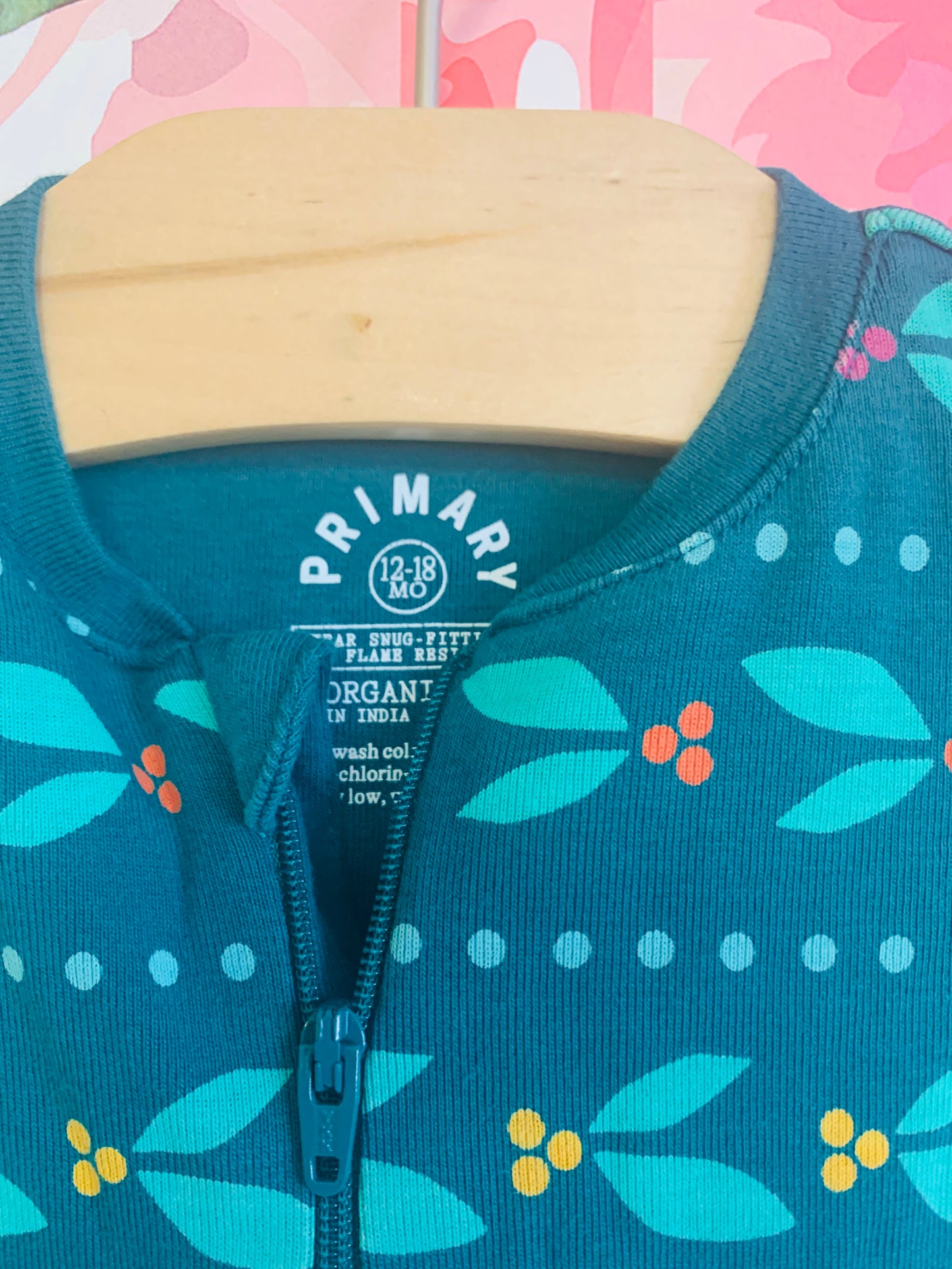 Primary green long sleeve footed romper with berry/leaf design. Grippers on bottoms of feet. Size 12-18m