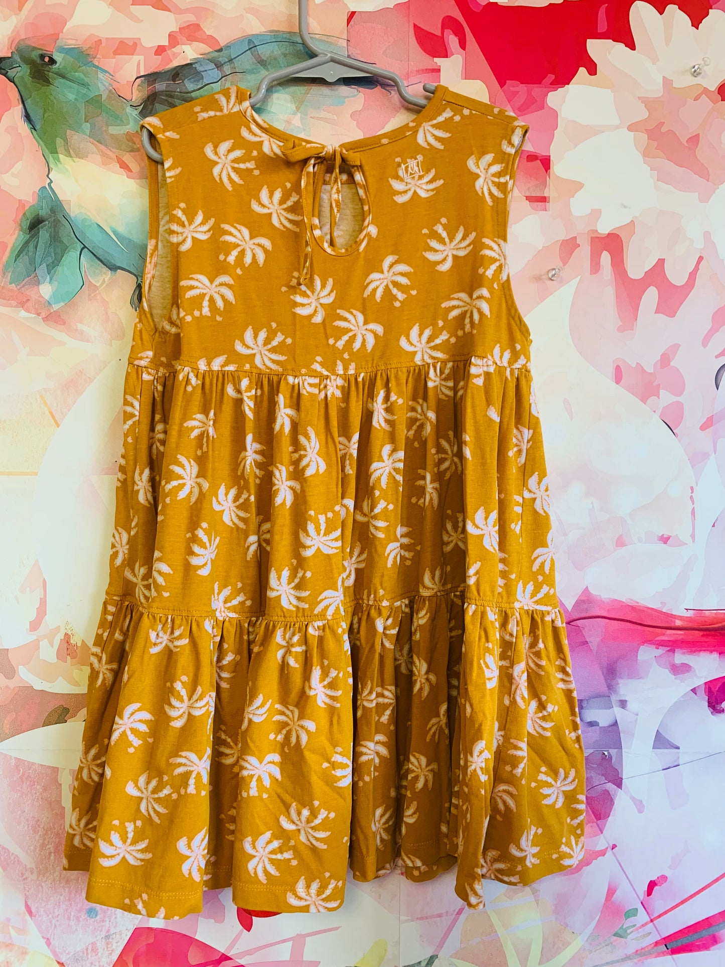 Munster yellow sleeveless tunic top with white/pink palm trees. Neck tie at back. Size 7