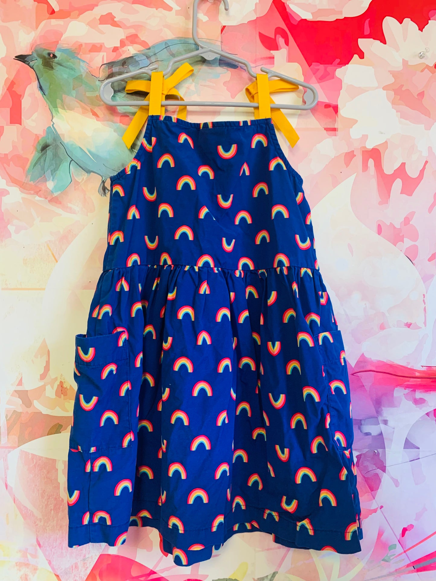 Hanna Andersson blue dress with rainbows, front pockets & yellow shoulder ties. Size 6/7