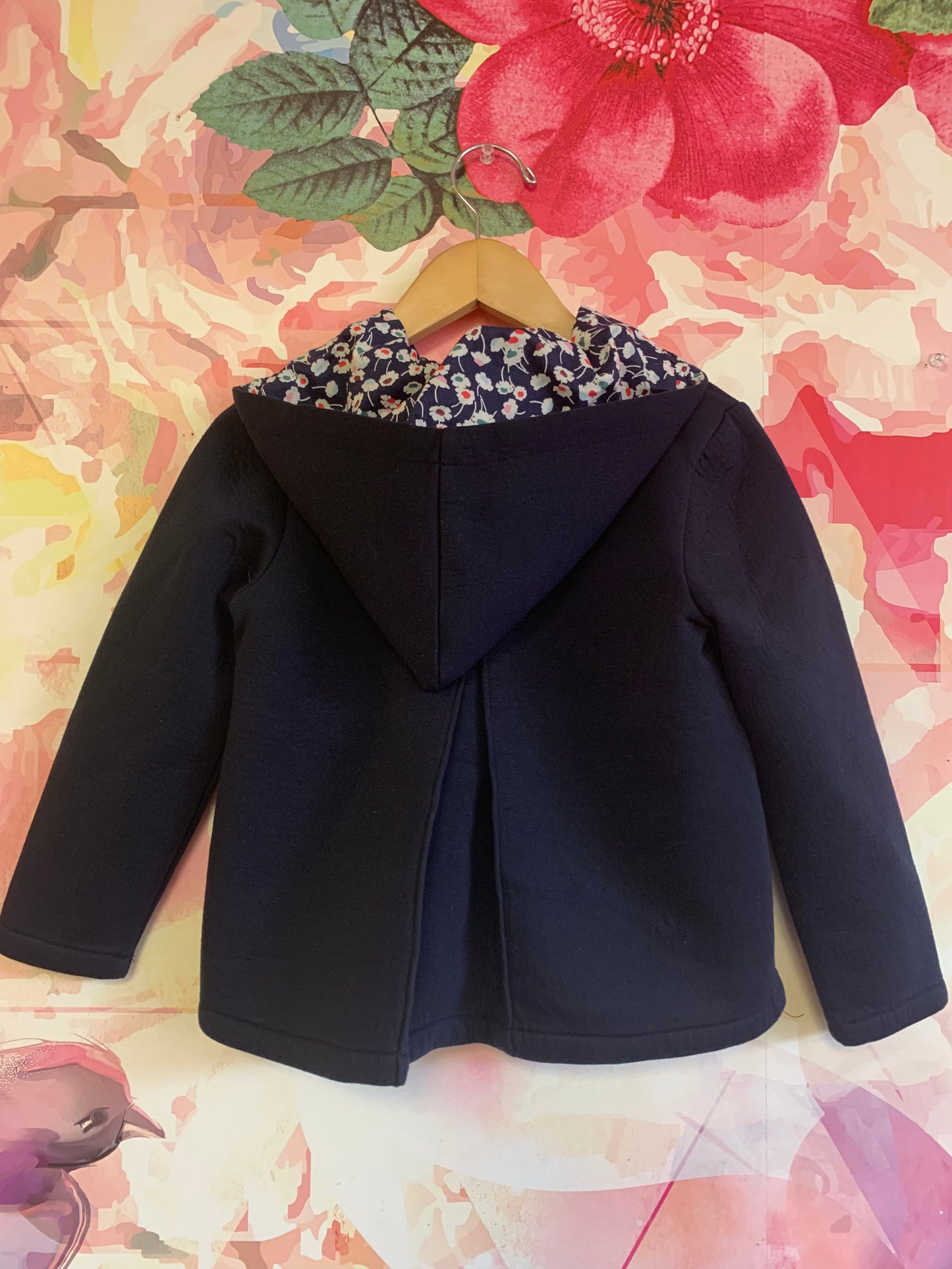 Jacadi blue zip up hoodie. Floral lining inside hood. Front pockets. Split hem back. Size 6.