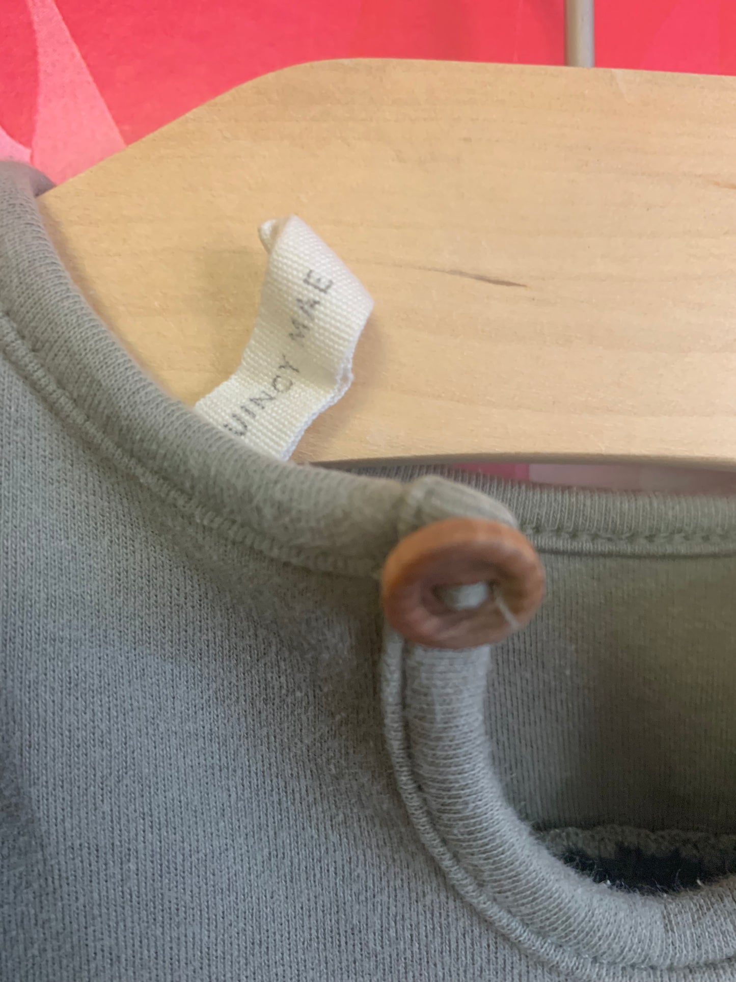 Quincy Mae olive long sleeve too with shoulder ruffles & elastic at wrists. Button closure on back of neck. Size 12-18m