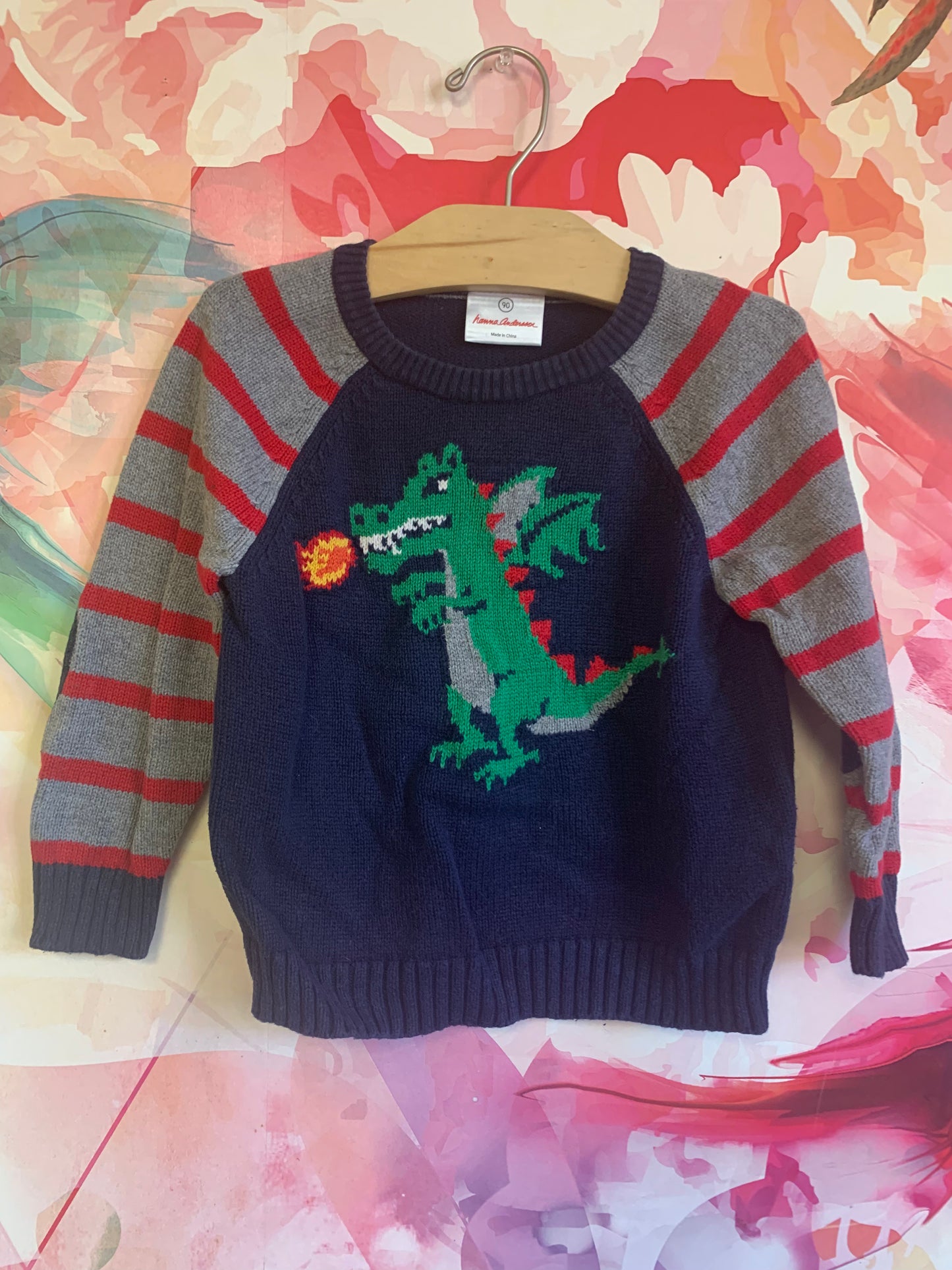 Hanna Andersson blue crewneck sweater with green dragon blowing fire. Red & grey stripe sleeves and blue elbow patches. Size 3T