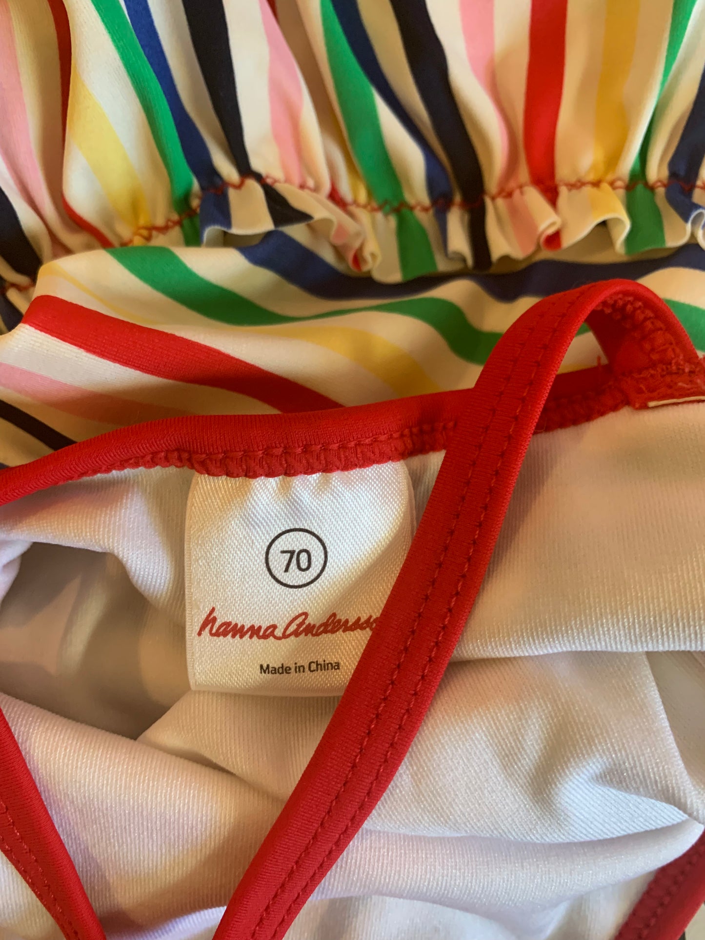Hanna Andersson rainbow stripe one piece swimsuit with skirt. Criss cross straps on back. Size 6m
