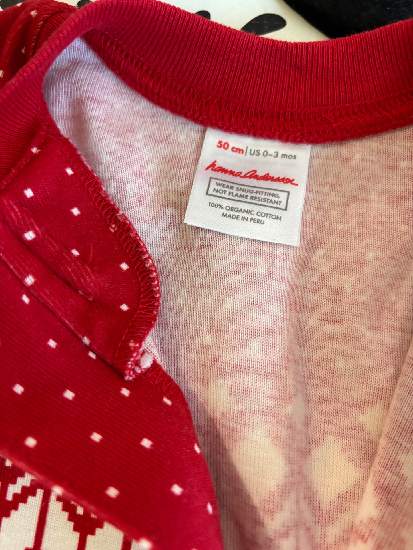 Hanna Andersson red long sleeve romper with black, grey, white snowflake winter design. Size 0-3m NB