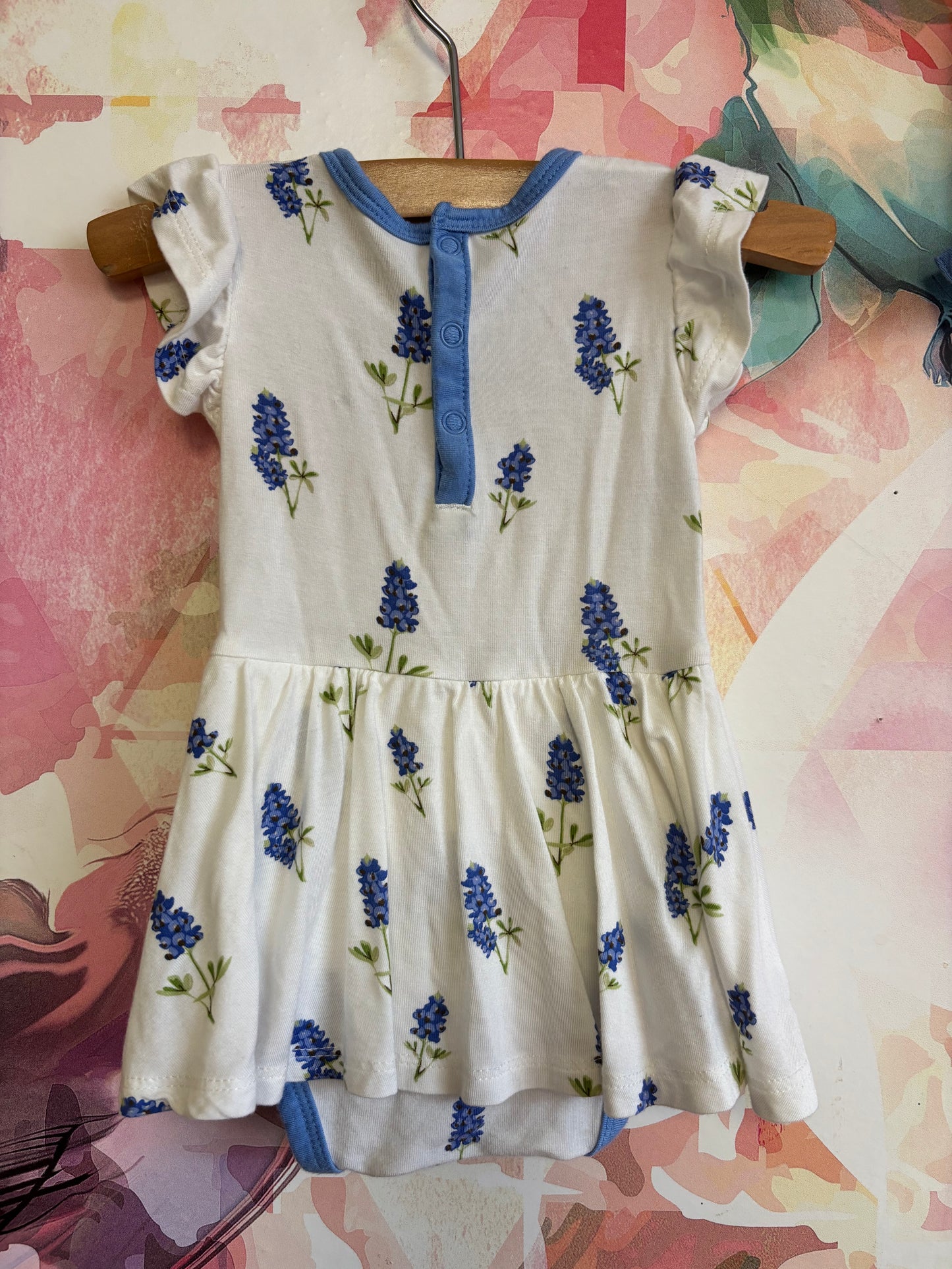 Kyte Baby white dress onesie with blue flowers and blue headband. Made of Bamboo size 0-3m NB