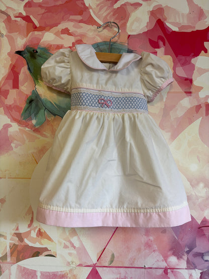 The Beaufort Bonnet Company white short sleeve dress. Blue & pink bow and pink hem. Size 6-12m