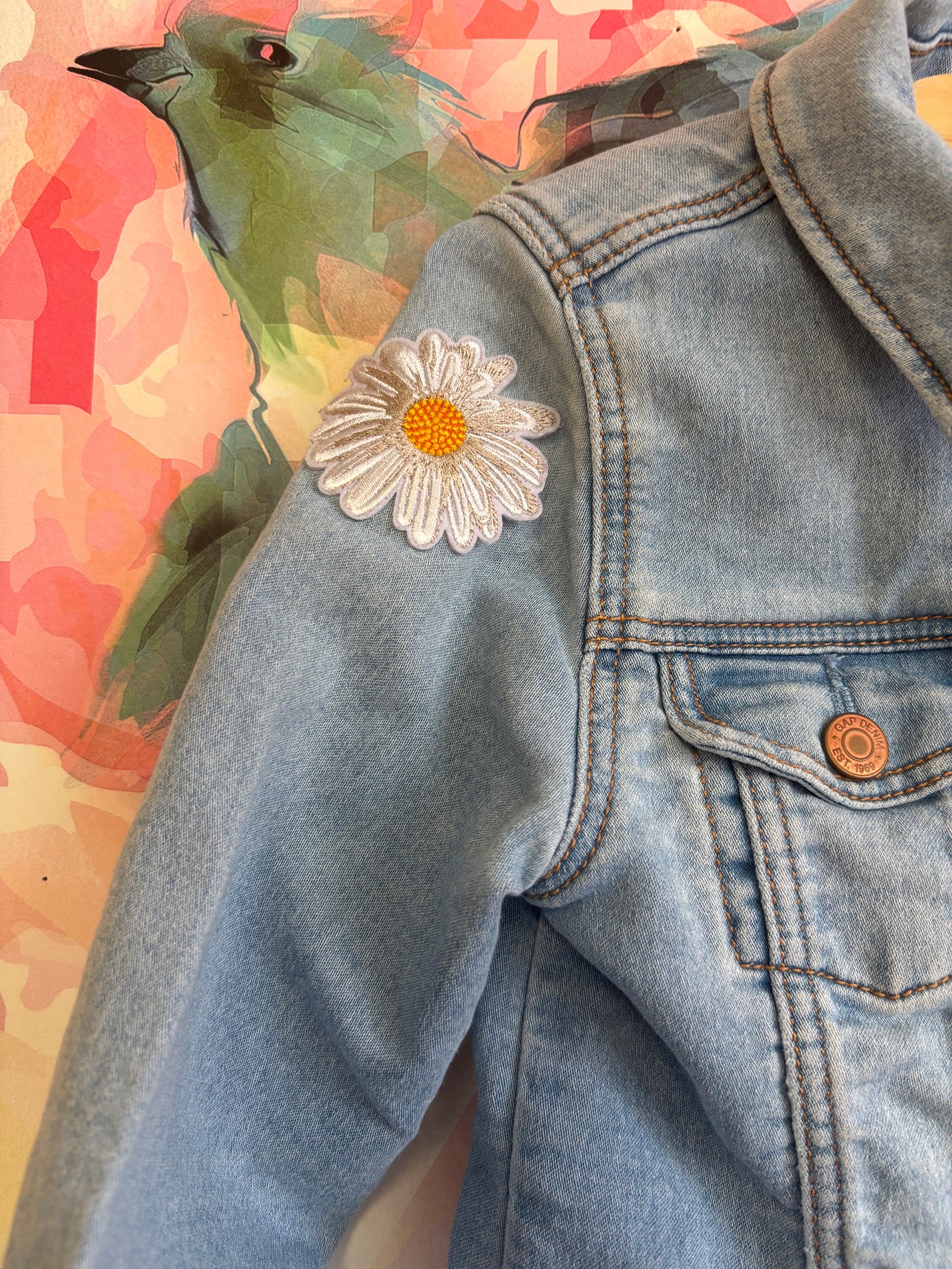 Baby Gap light blue denim jacket with sunflower and feather patches on sleeves. Snap closure. Size 5T