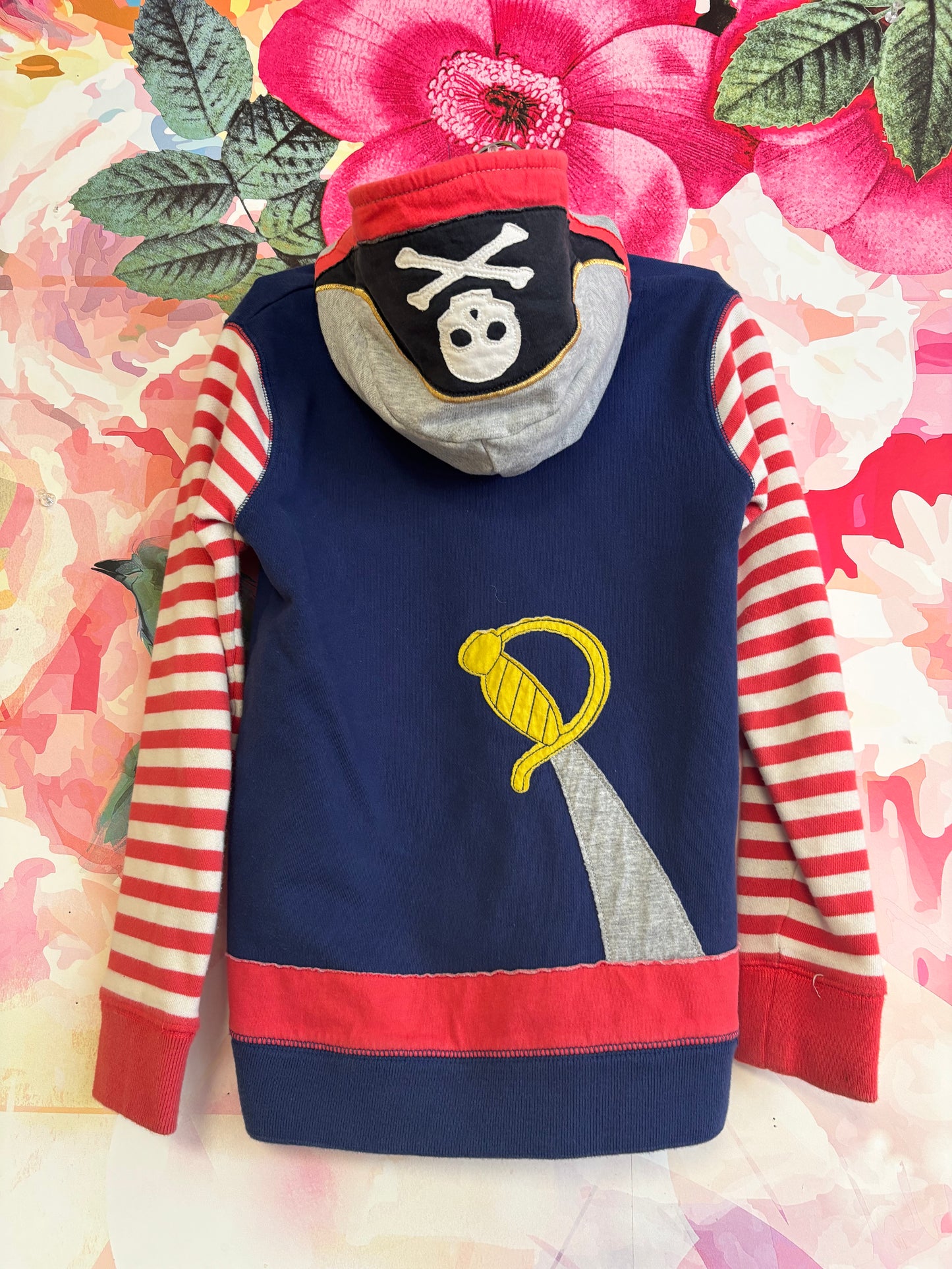 Mini Boden blue zip up pirate hoodie with red/white stripe sleeves, sword on back. Size 7/8