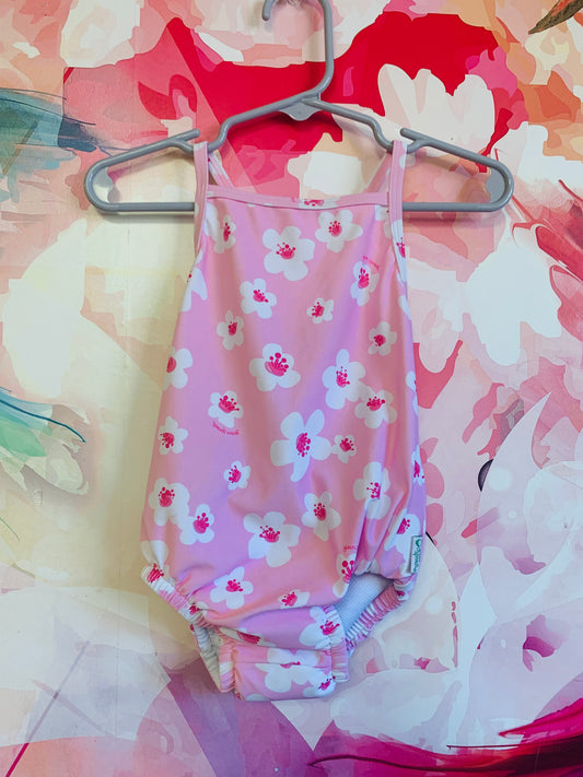 Green Sprouts pink swimsuit with built-in swim diaper. Criss cross straps on back. Size 6m.