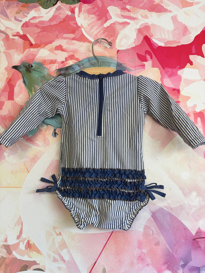 Ruffle Butts blue/white stripe long sleeve swimsuit with ruffles on back. Size 12-18m