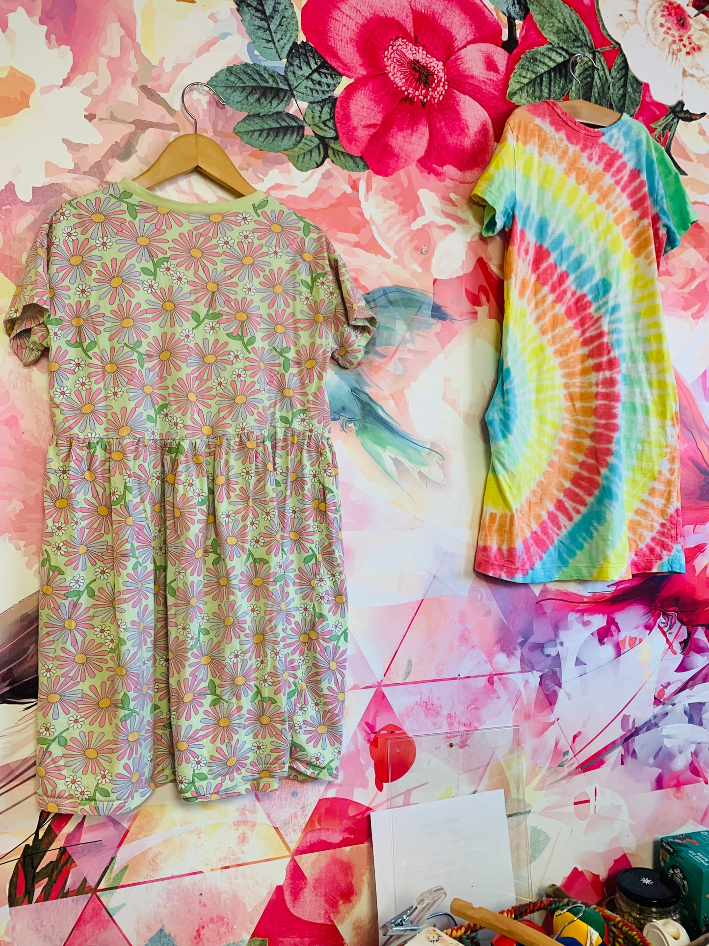 Two summer dresses. H&M short sleeve green, pink, purple, orange floral dress. Primary rainbow tie dye short sleeve dress with side pockets. Size 10.