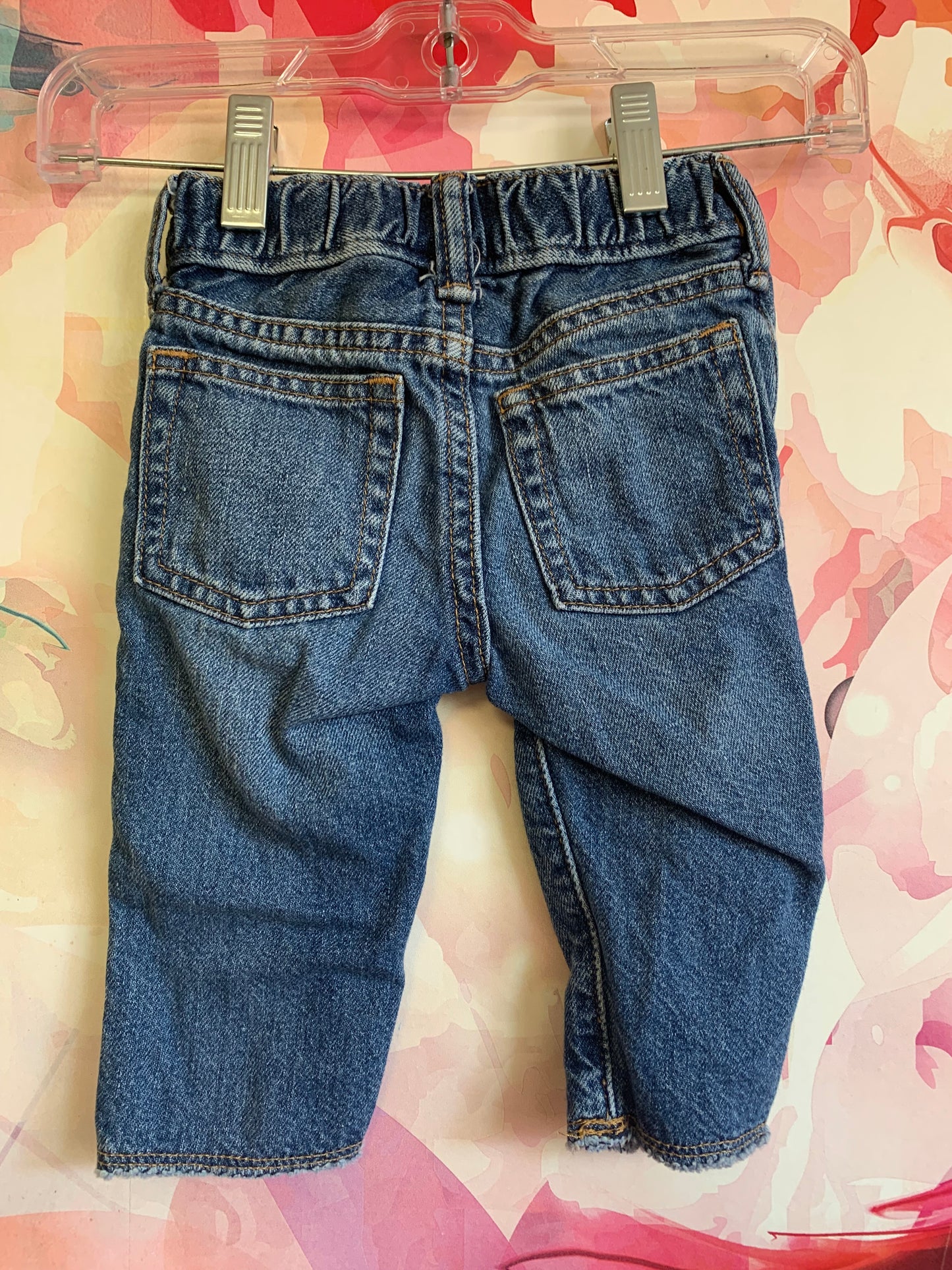 Baby Gap blue jeans with distressed knees and snap waist. Size 3-6m.