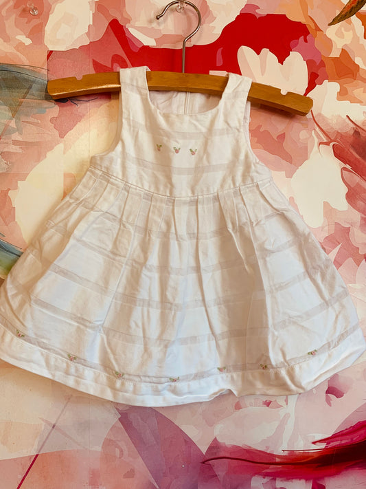 Ciccino white baby dress. Italian brand. 100% cotton. Pleats & tiny pink flowers on neck and front hem. Size 9m.