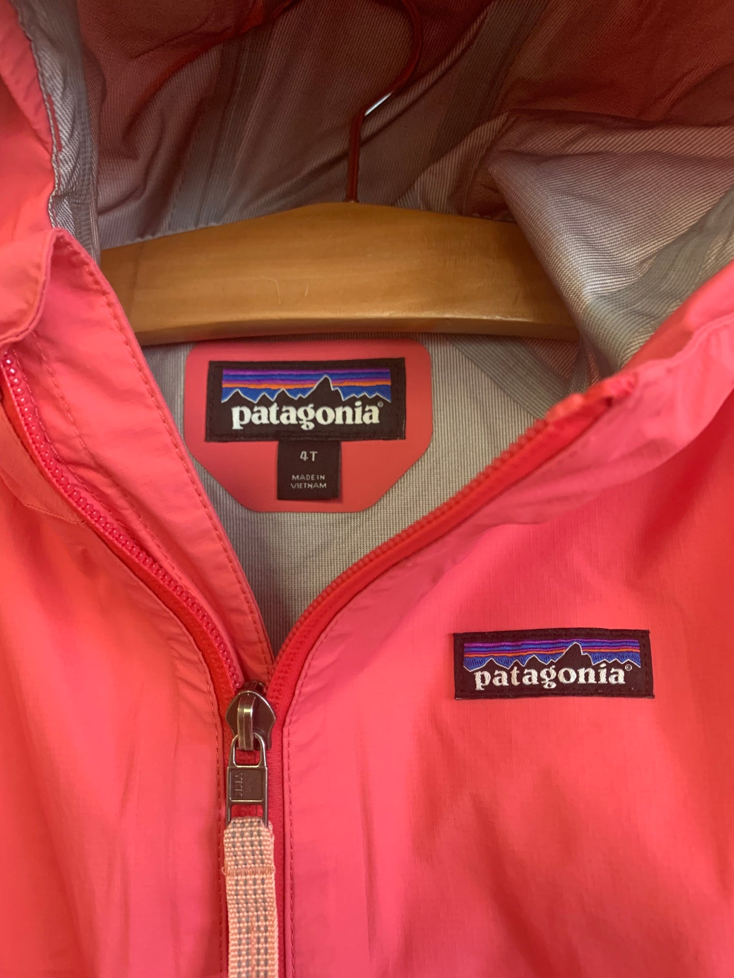 Patagonia pink raincoat with hood and reflective stripes. Size 4T.