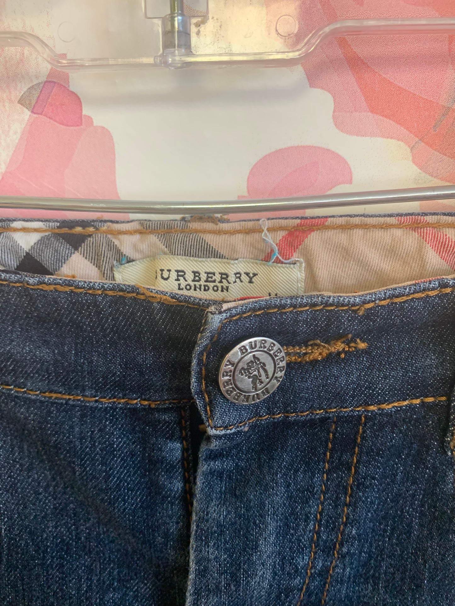 Burberry blue jeans with plaid rolled cuffs and detail on back pockets, inner waistband. Size 3/4T.