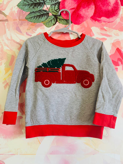 Monica & Andy grey sweatshirt with red neck & sleeve hems. Red truck with green Christmas tree. Size 2T. 2 available.